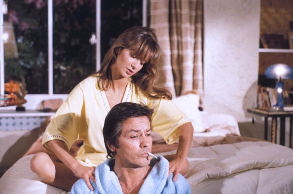 Alain Delon et Anne Parillaud sur le tournage du film 'Pour la peau d'un flic' réalisé par lui-même en 1981, Paris, France. | Photo : Getty Images