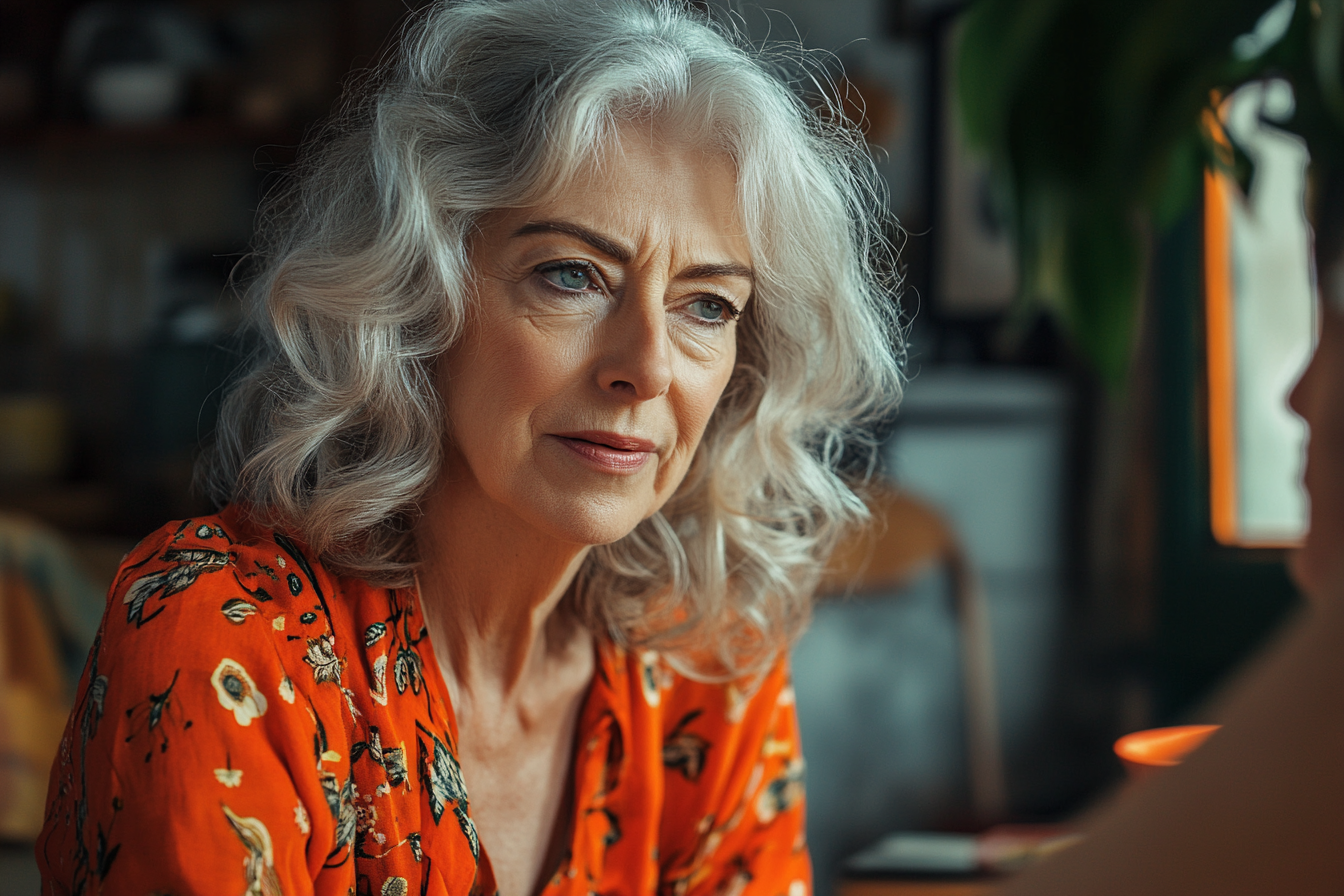 Une femme âgée qui regarde la personne assise en face d'elle | Source : Midjourney