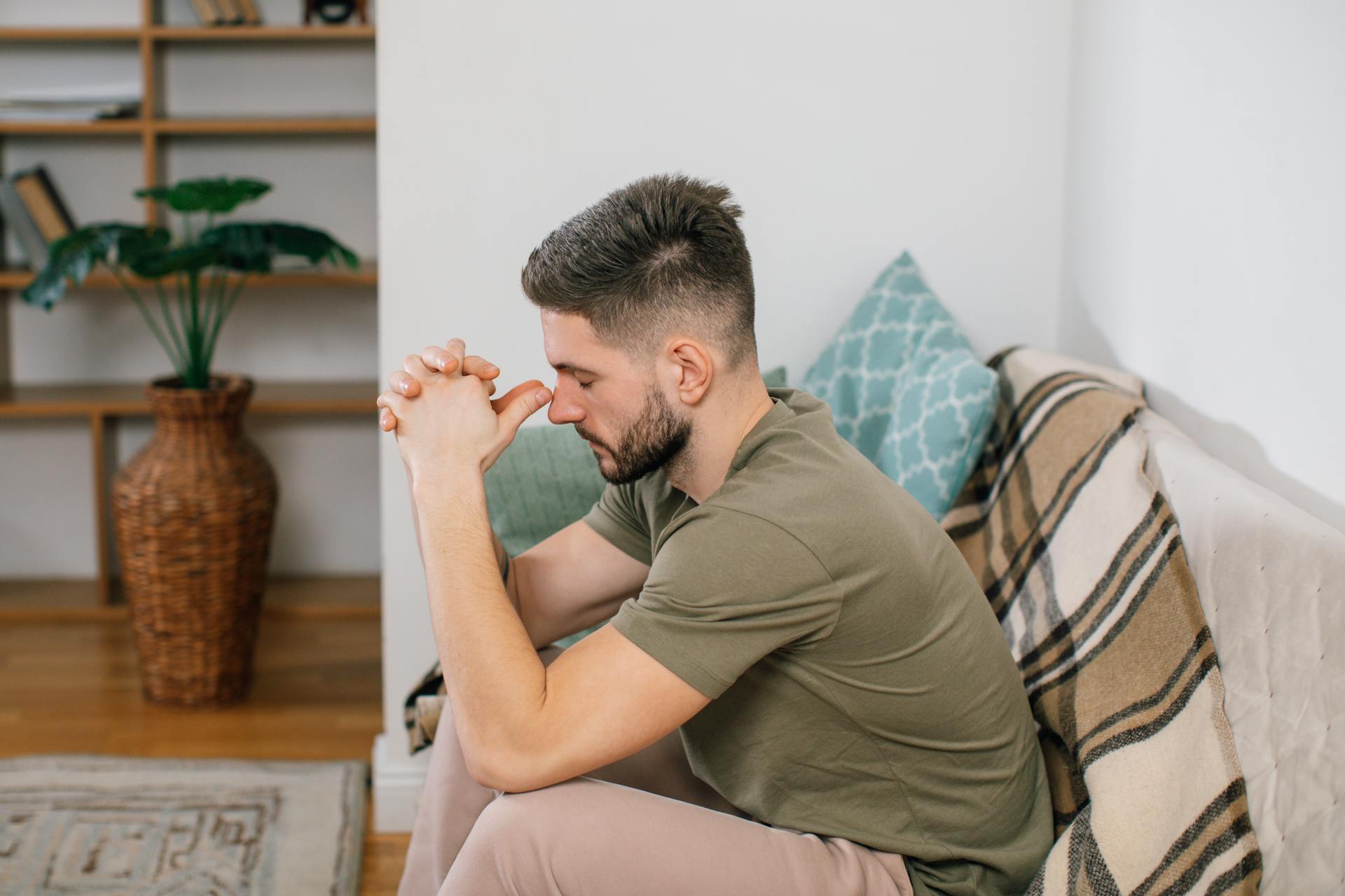 Un homme stressé assis sur un canapé | Source : Pexels