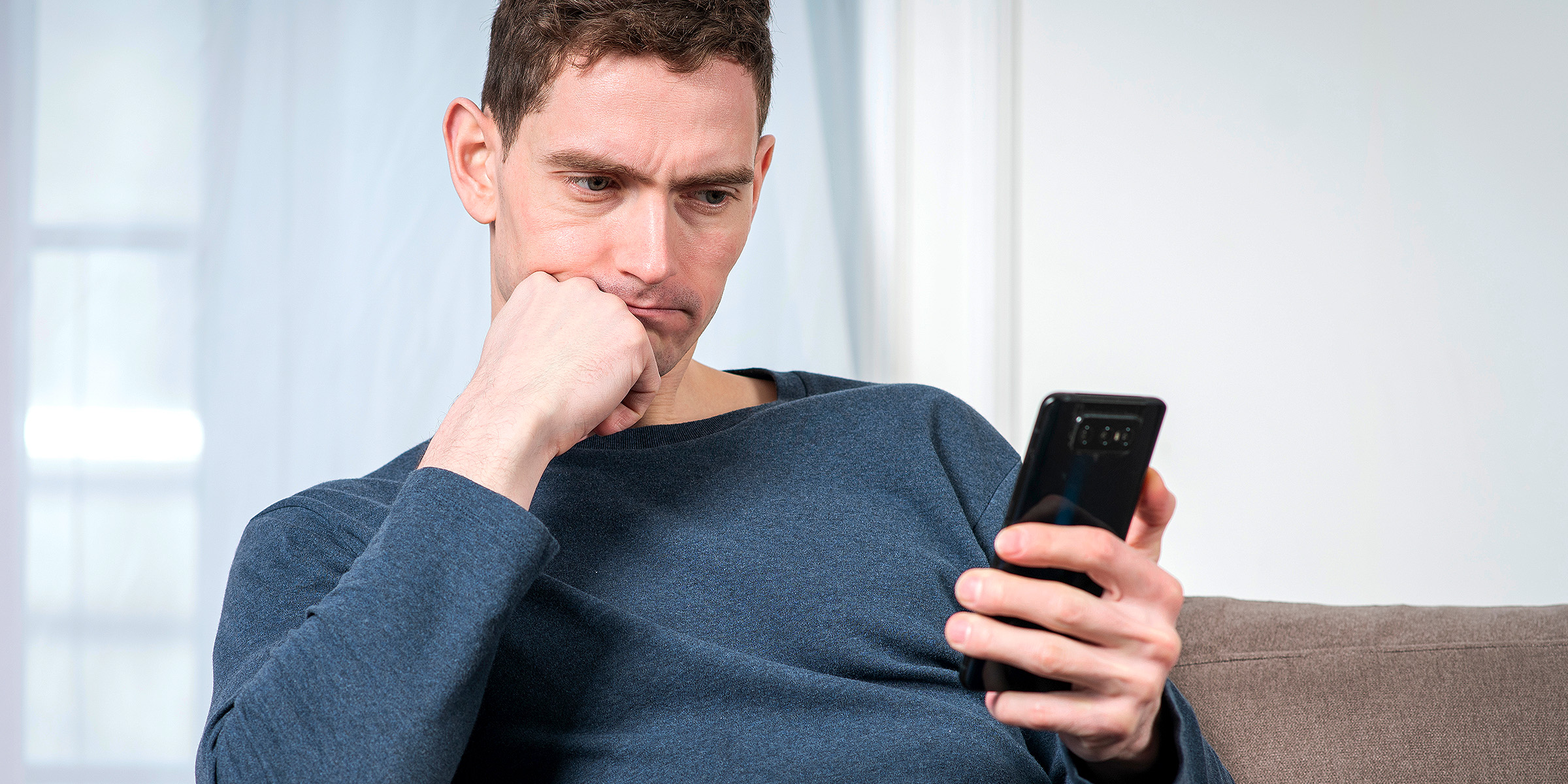 Un homme tenant un téléphone | Source : Shutterstock