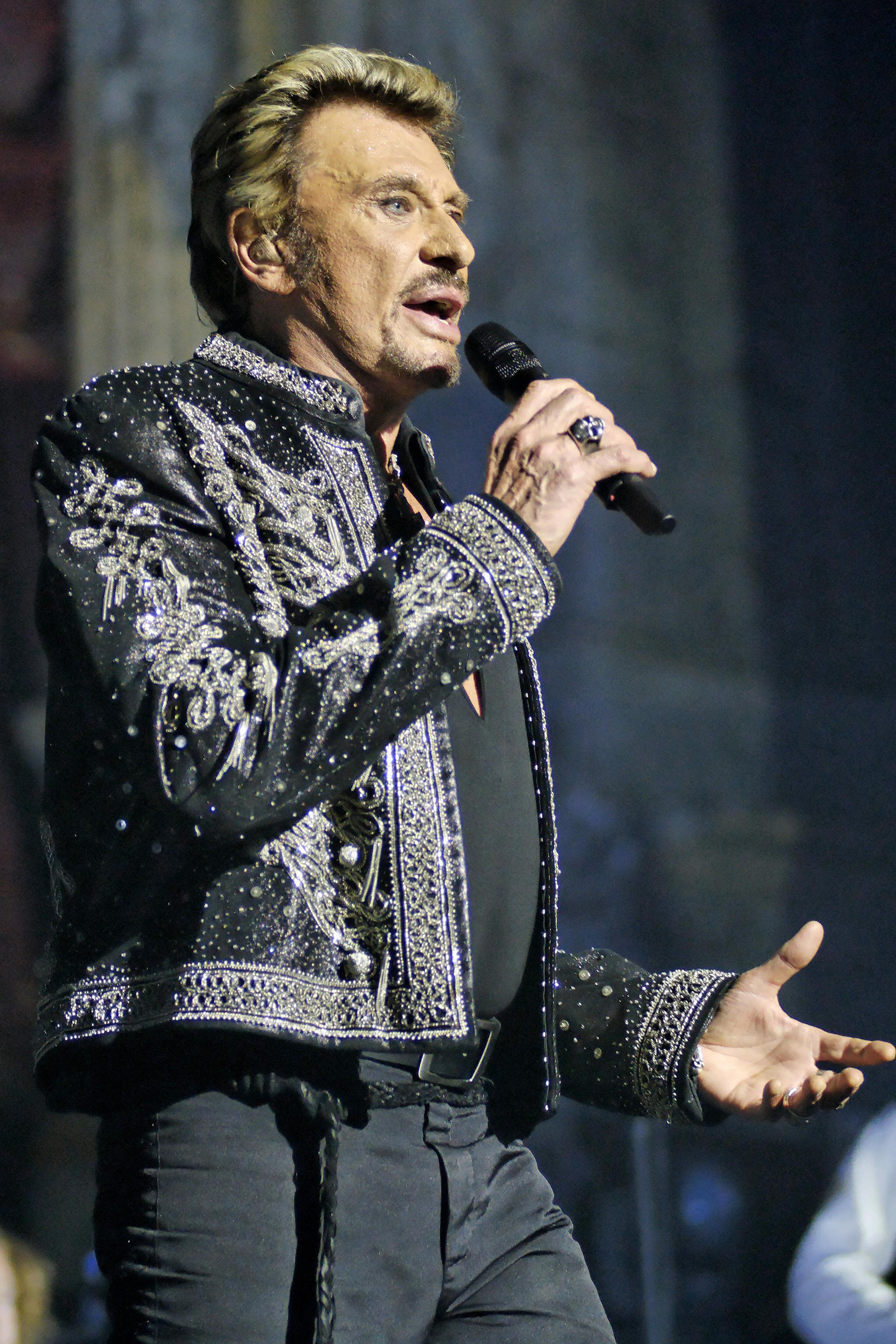 Le chanteur français Johnny Hallyday se produit sur scène lors d'un concert le 27 octobre 2006 à Bruxelles I Source : Getty Images