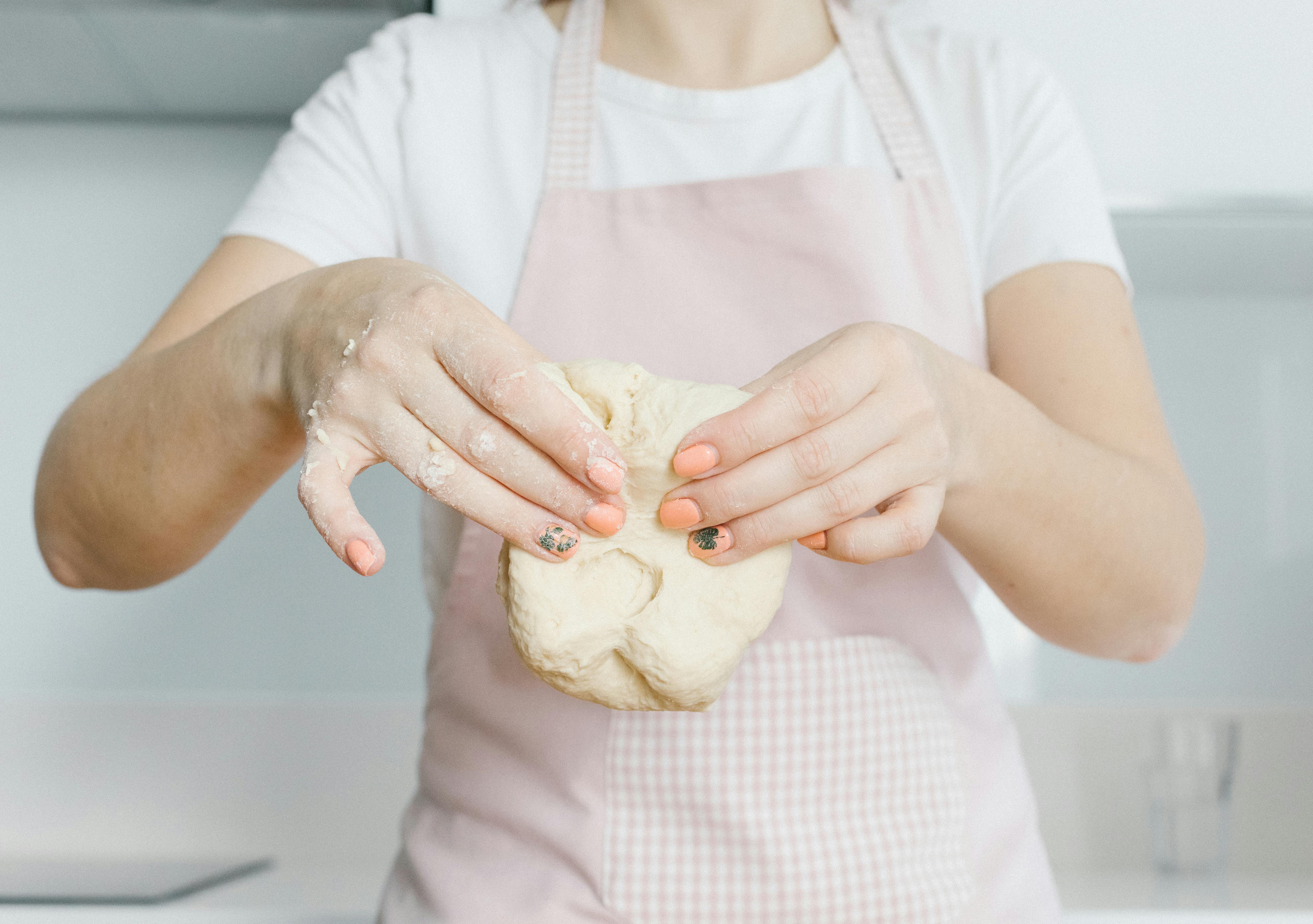 A woman holding bread dough | Source: Pexels