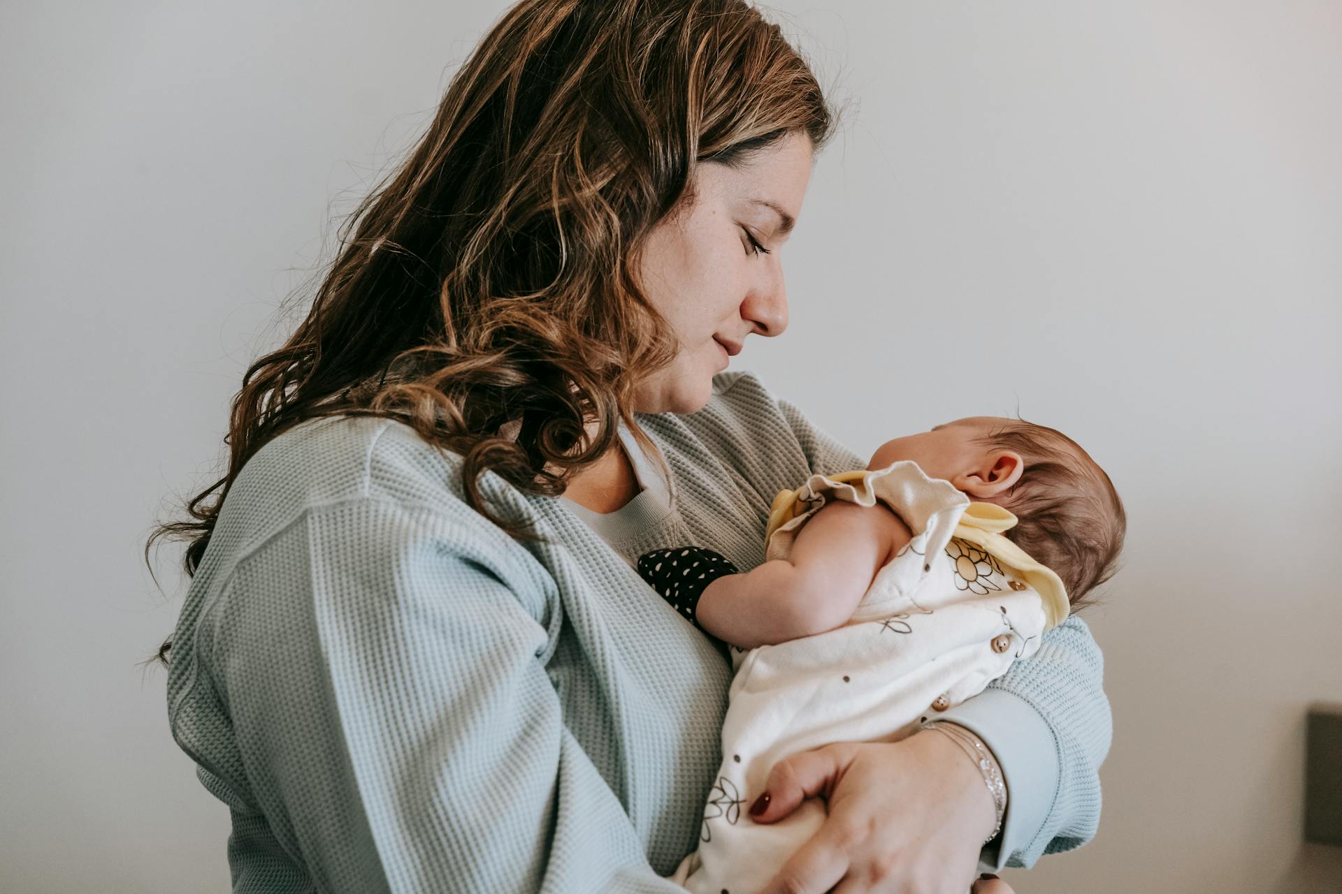 Mère heureuse et paisible faisant des câlins à son enfant | Source : Pexels