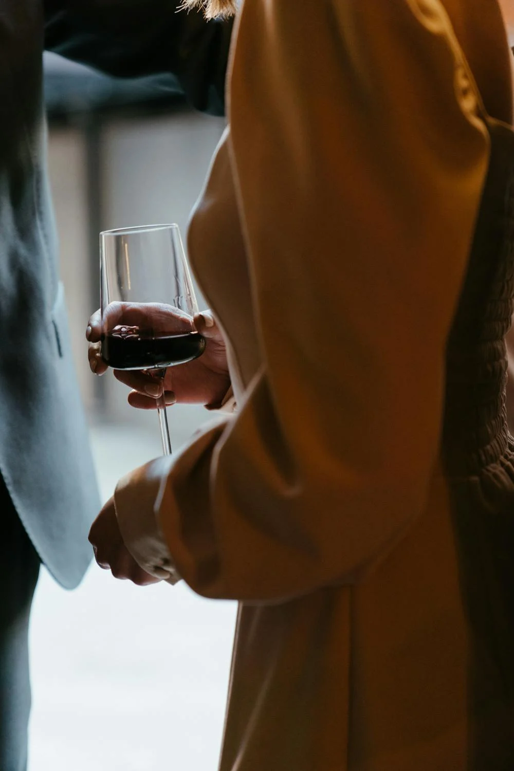 Une femme tenant un verre de vin rouge | Source : Pexels