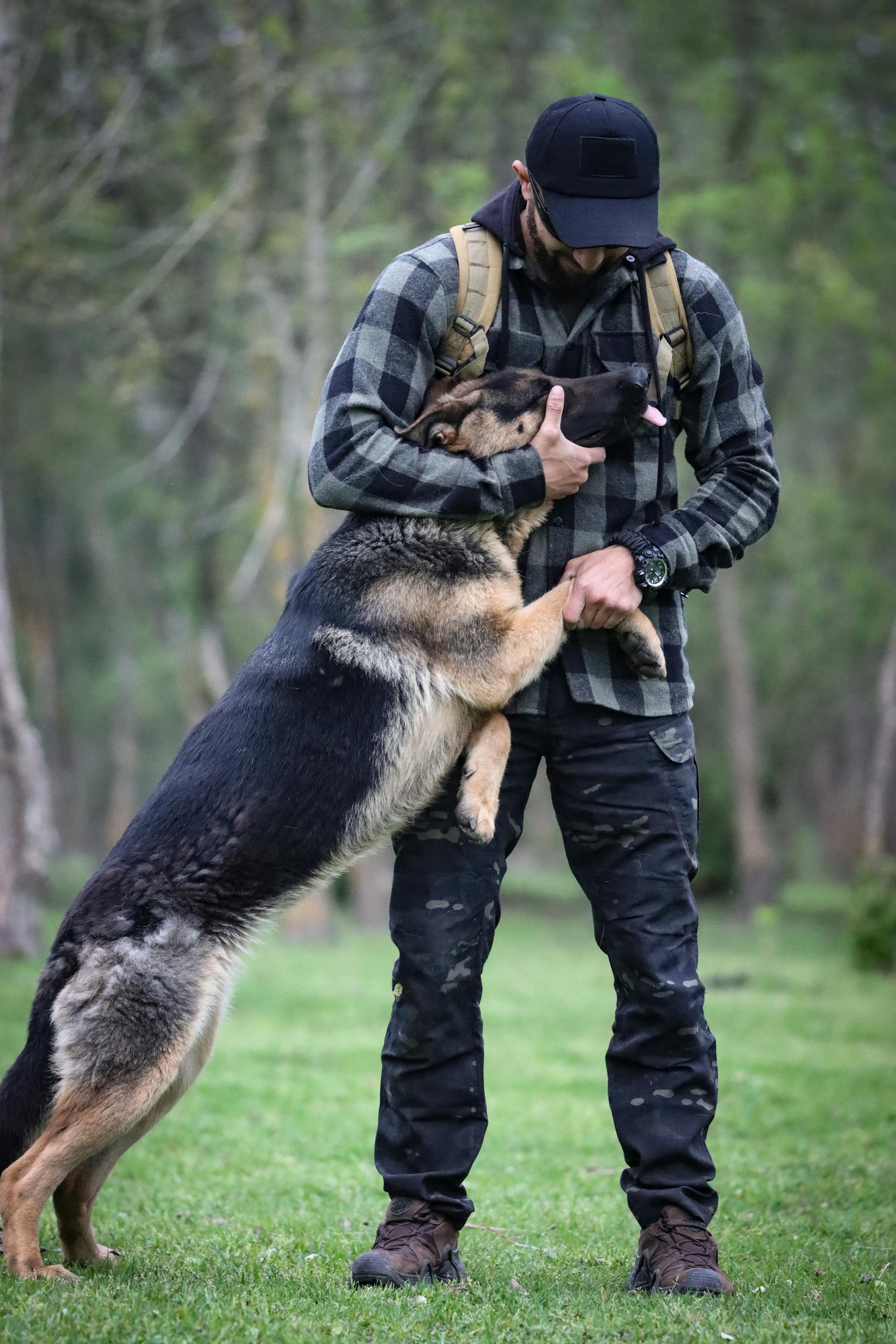 Un homme serrant un adorable chien dans ses bras | Source : Pexels