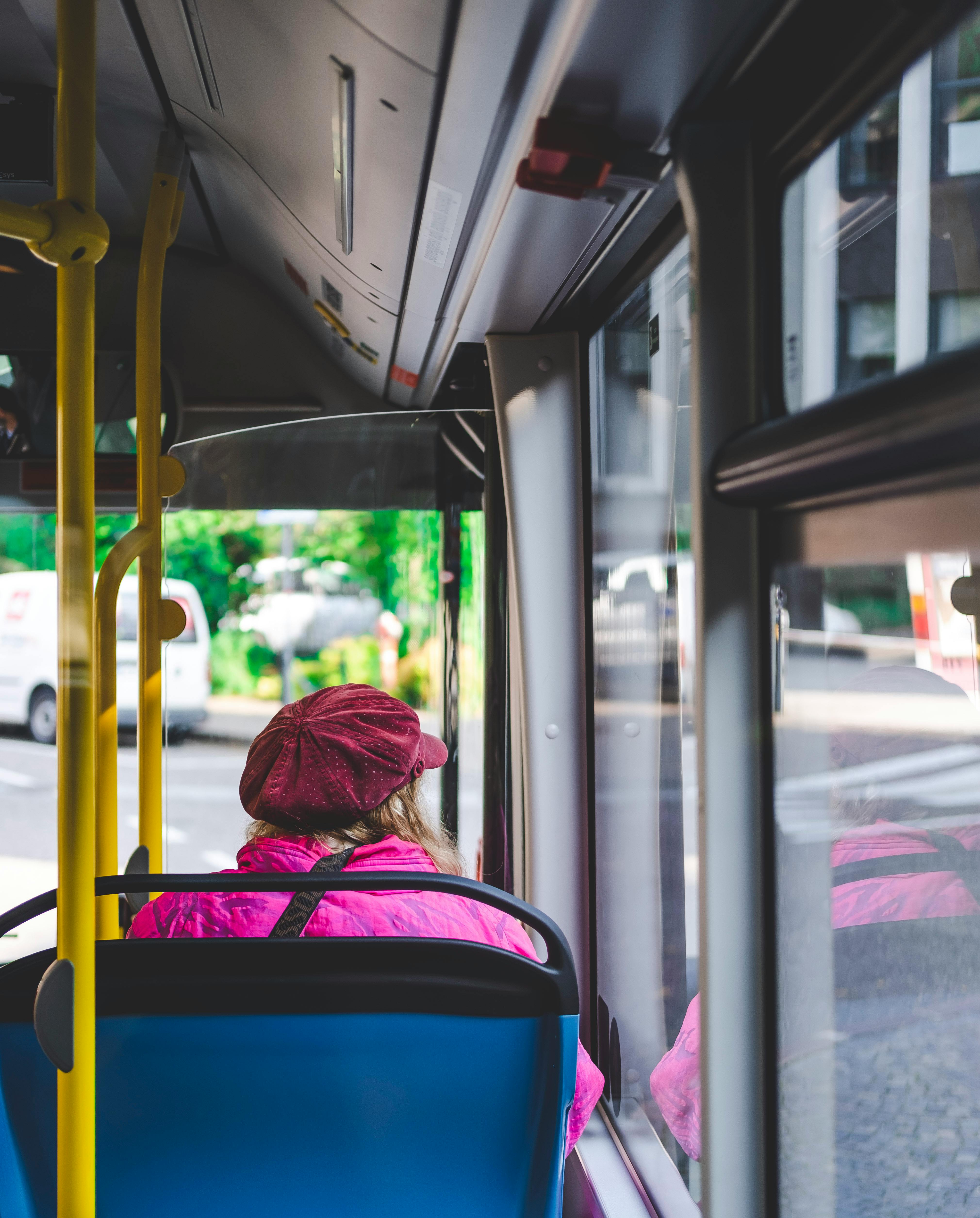 A woman helps an elderly woman sit on a crowded bus | Source: Pexels