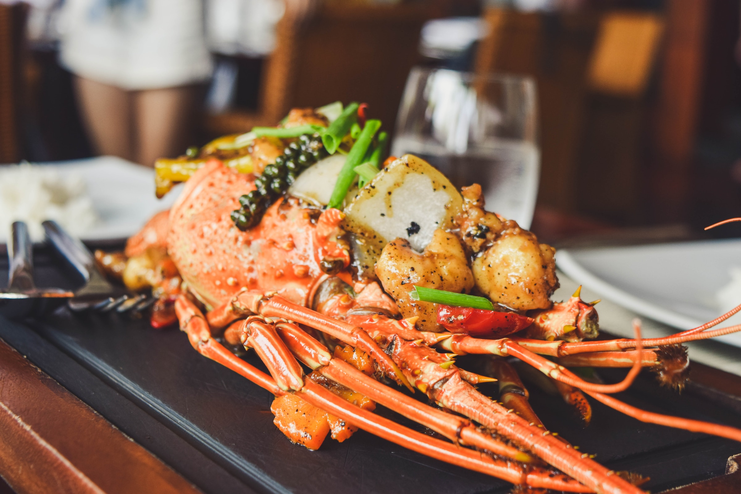 Lobster served on a black platter in a restaurant | Source: Unsplash