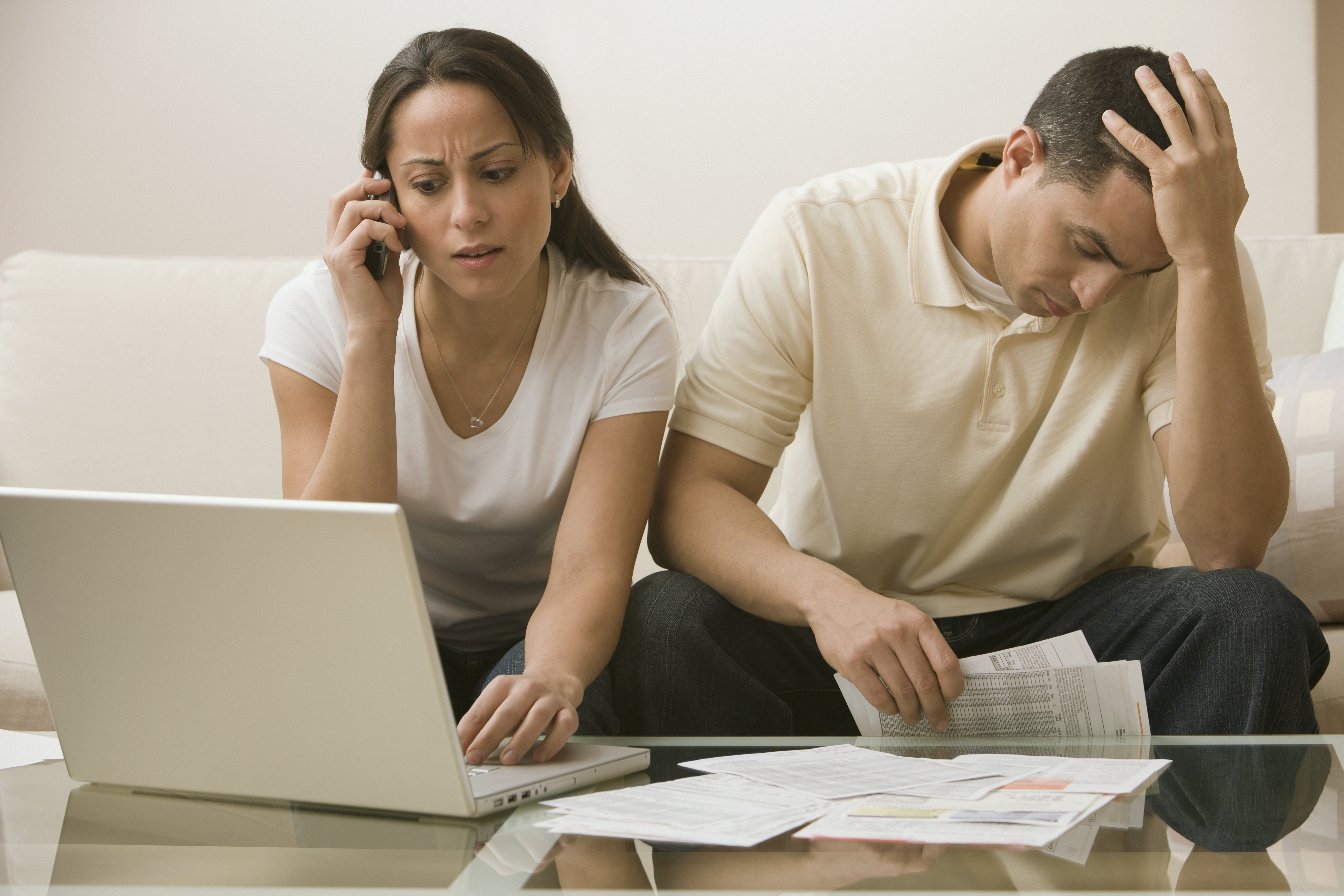 Un couple hispanique ayant des difficultés à payer ses factures en ligne | Source : Getty Images
