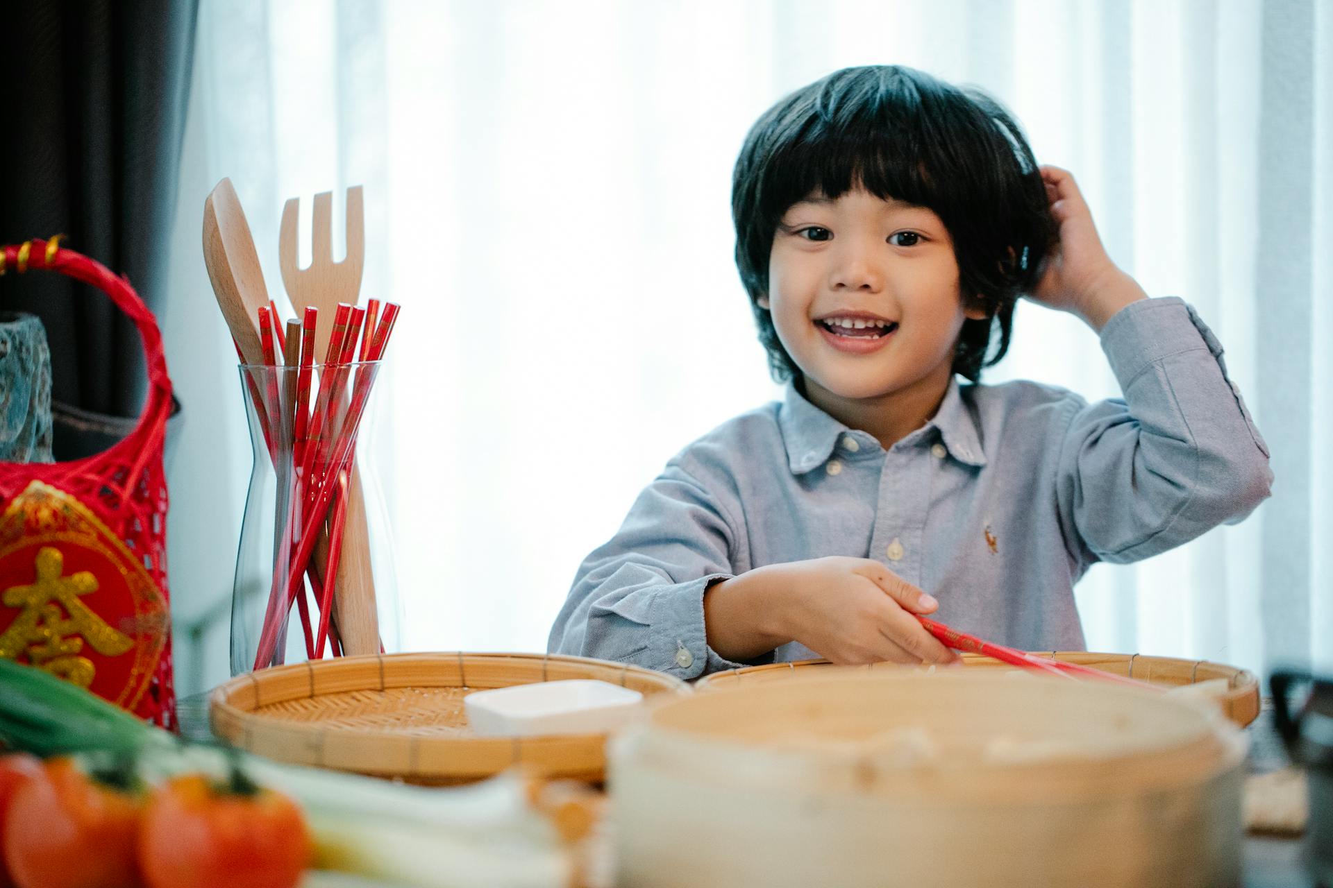 Un enfant assis à une table remplie d'un assortiment d'objets | Source : Pexels