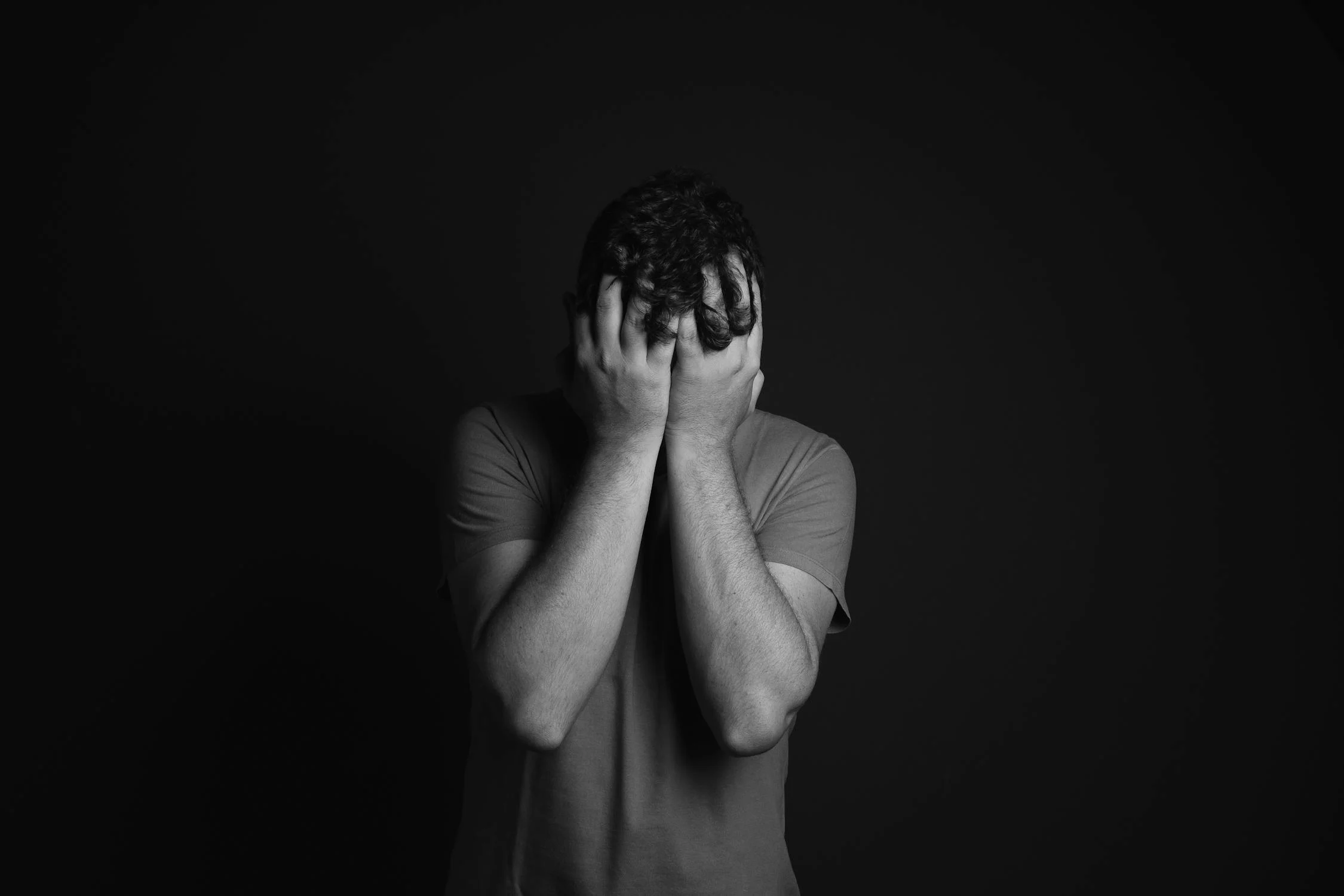 A sad man hiding his face | Source: Pexels