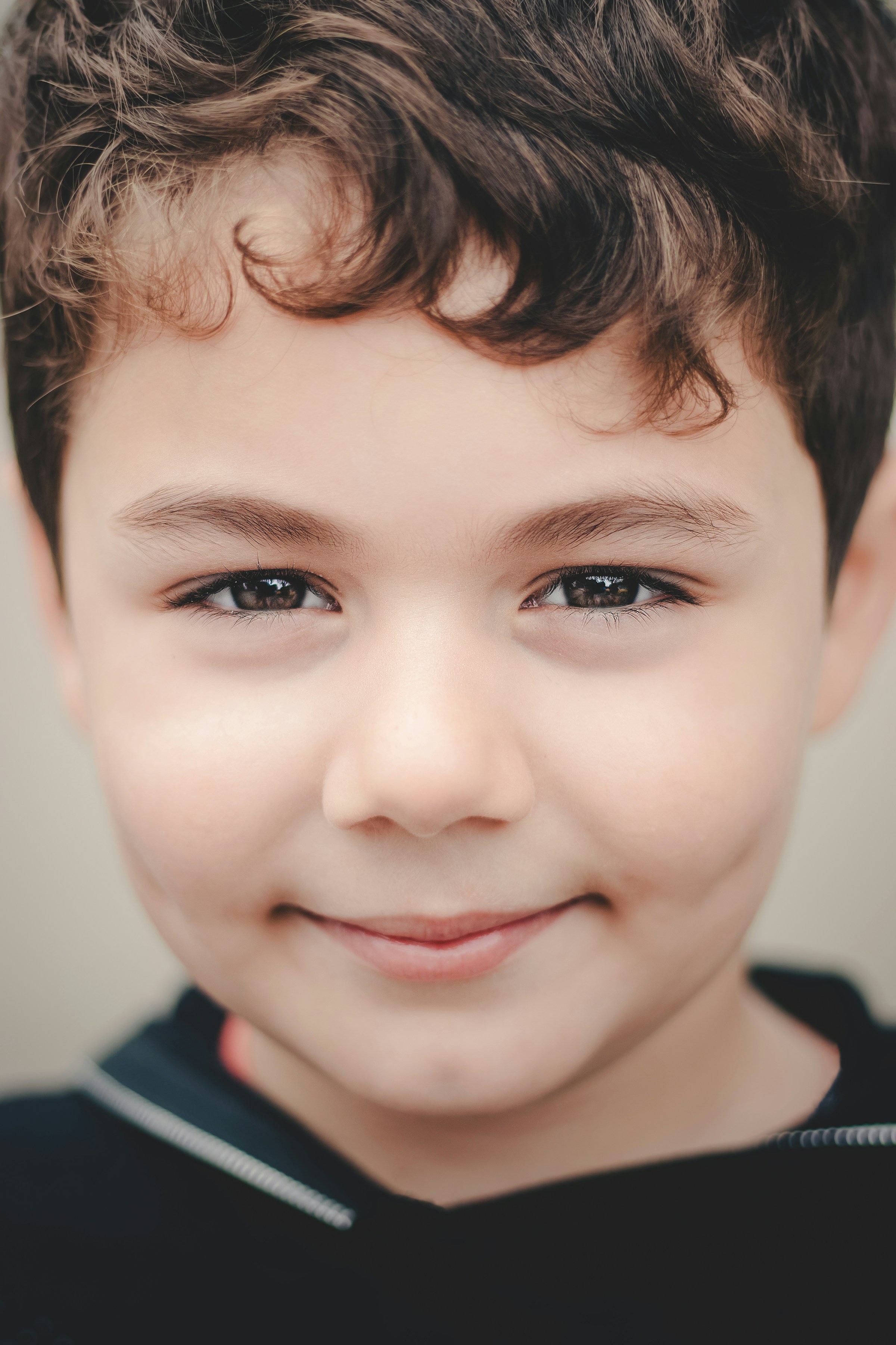 Close-up of a boy's smiling face | Source: Unsplash