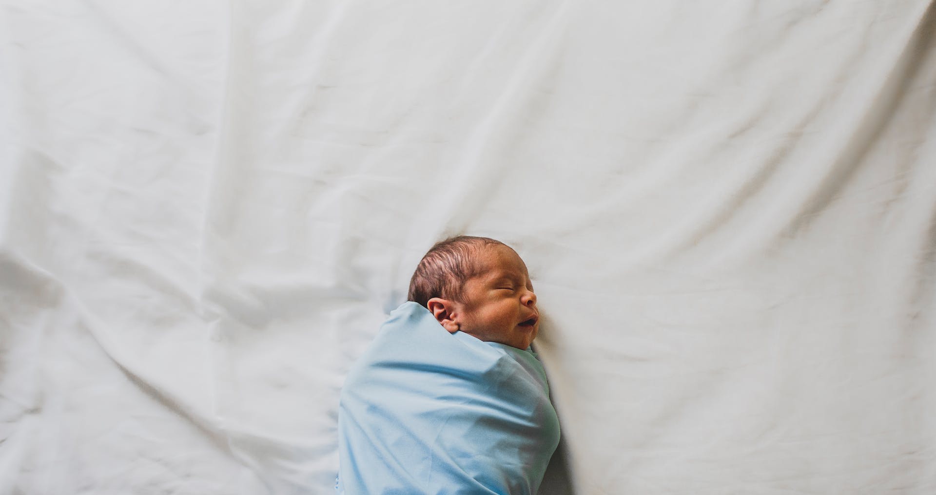 Garçon nouveau-né enveloppé dans une couverture bleue | Source : Pexels