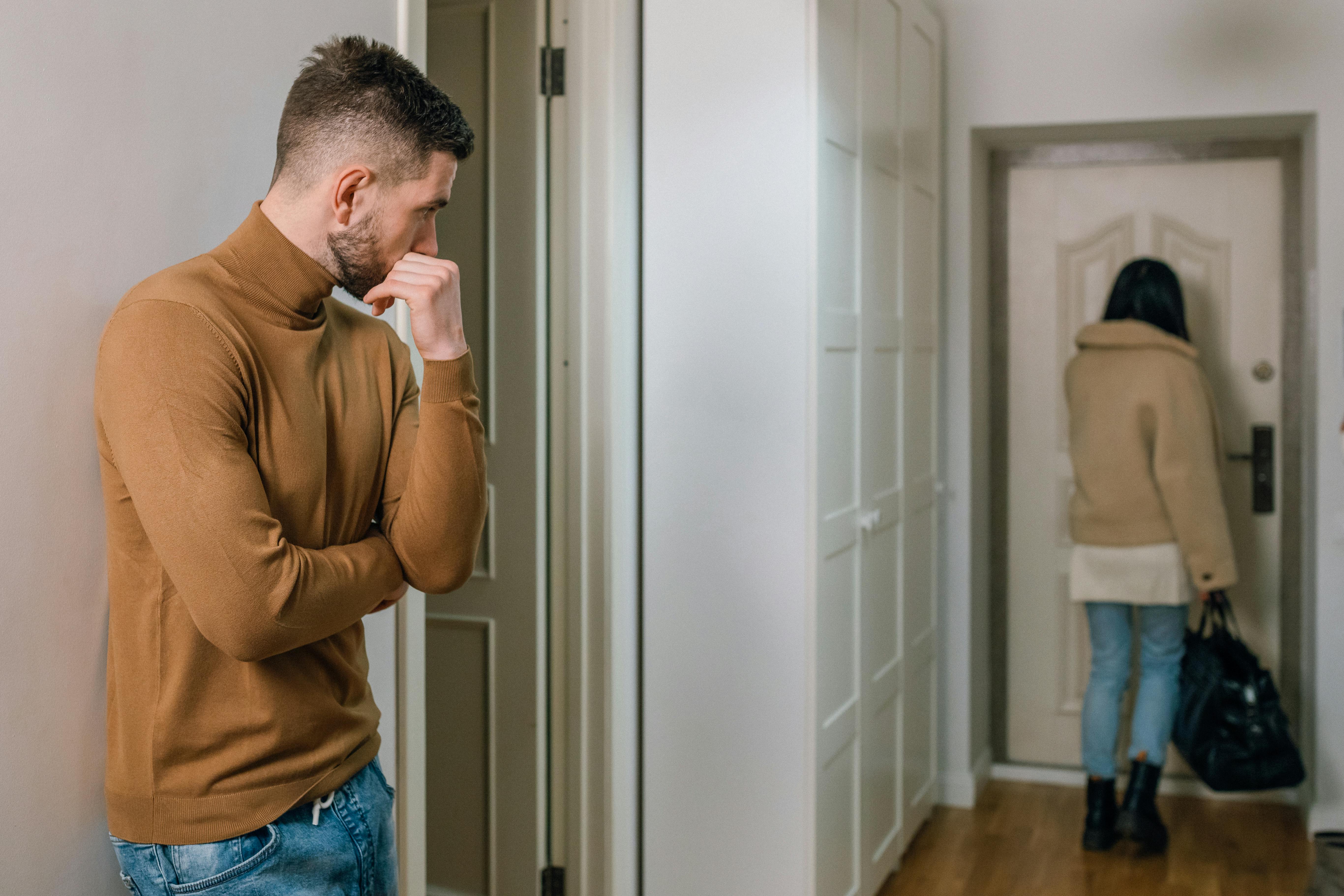 A woman walking away while a man looks at her | Source: Pexels