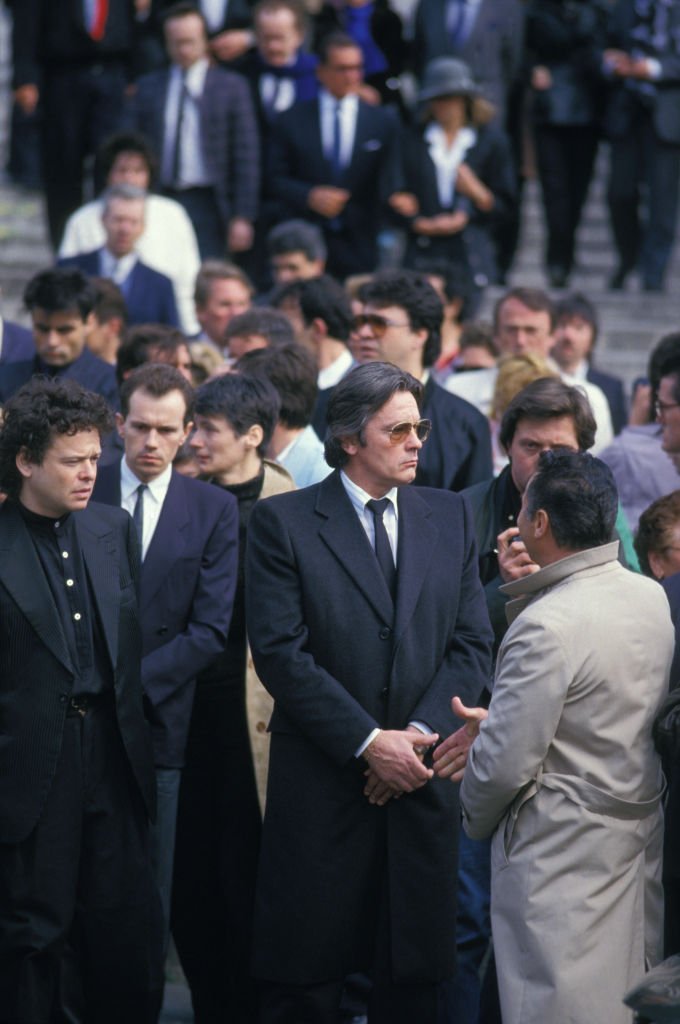 Alain Delon aux obsèques de la chanteuse Dalida le 7 mai 1987 à Paris, France.| Photo : Getty Images