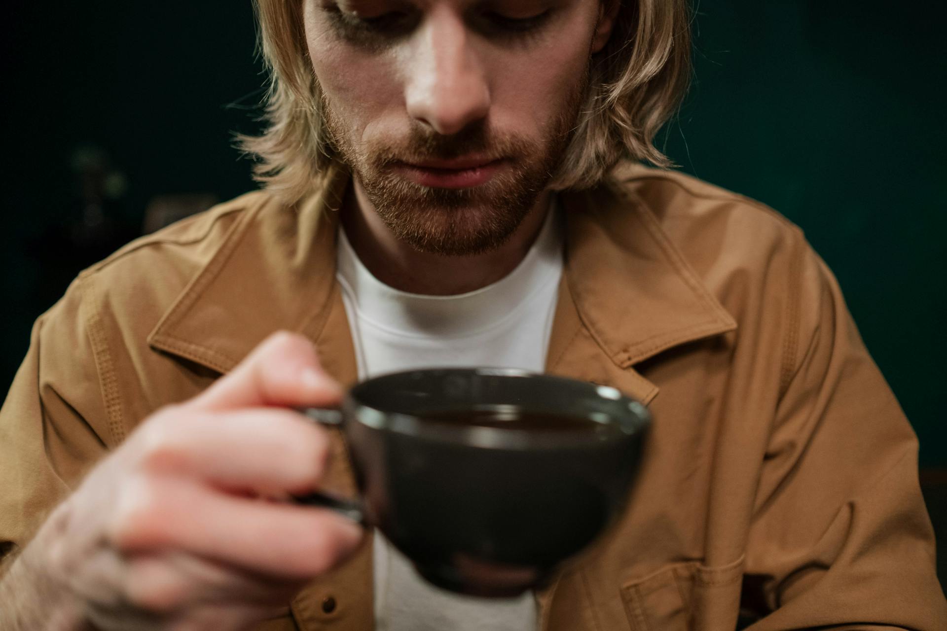 Un homme soulagé tenant une tasse de café | Source : Pexels