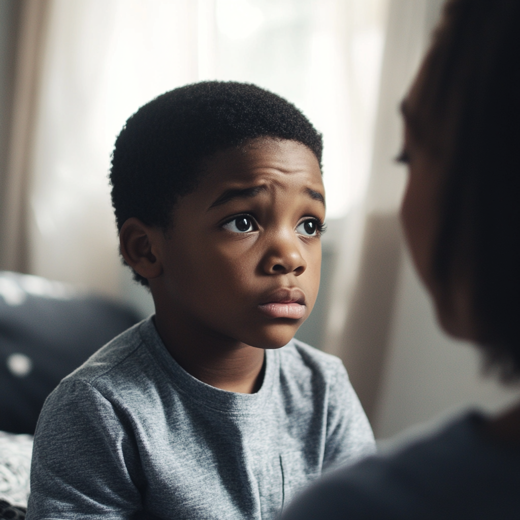 Sad boy talking to his mother | Source: Midjourney