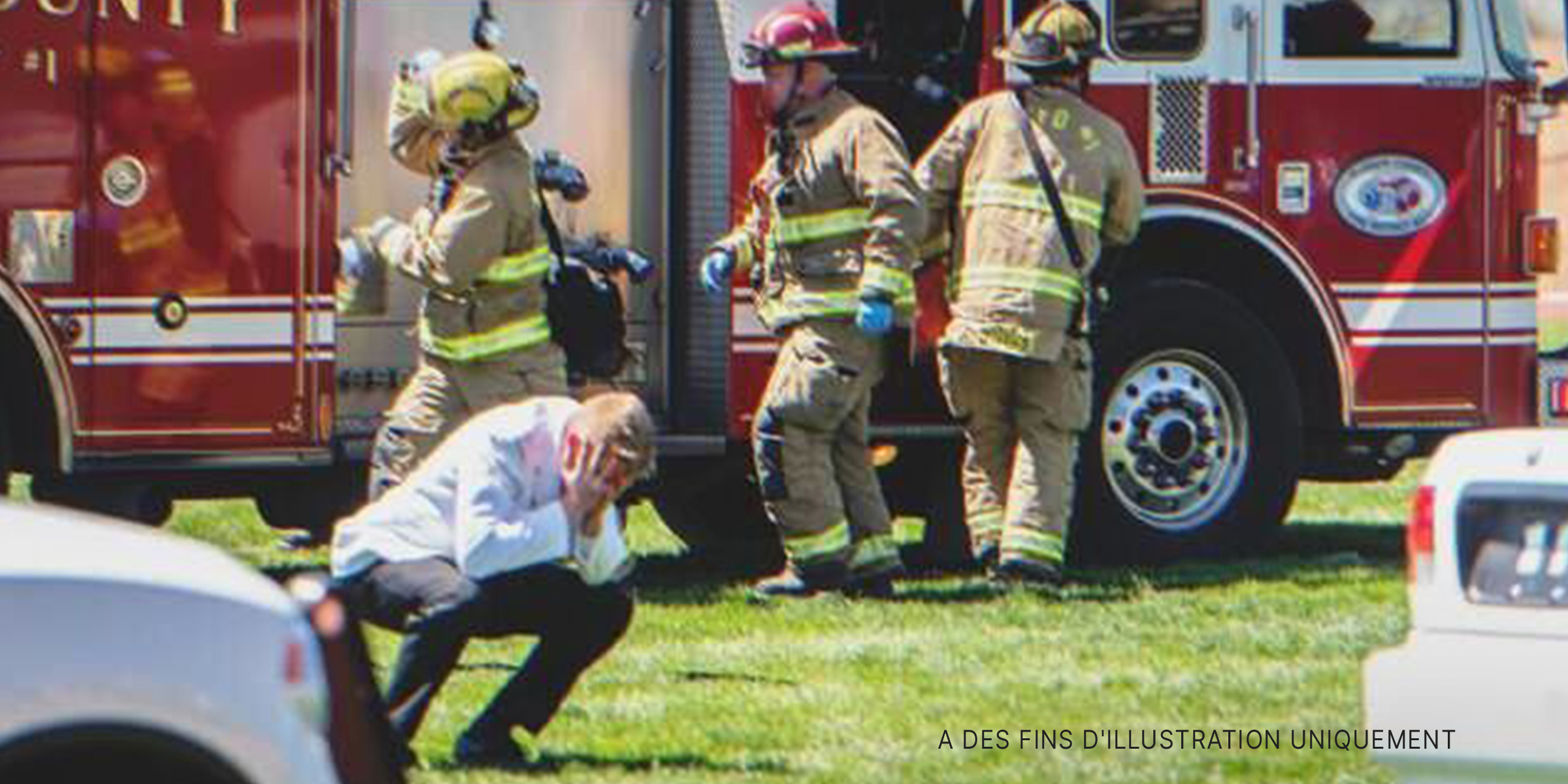 Un homme se tient la tête entre les mains devant un camion de pompiers | Source : Shutterstock
