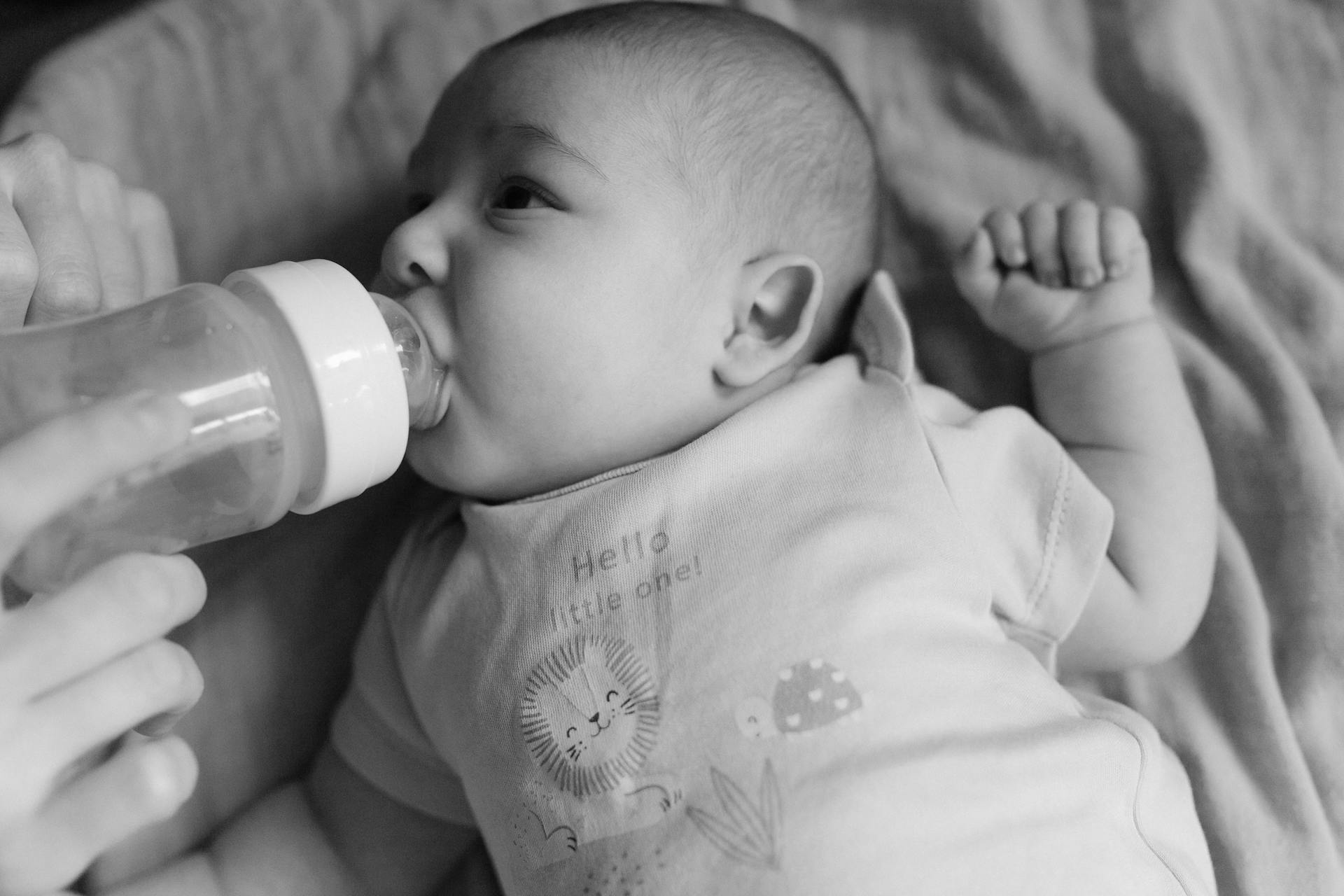 Un parent tenant un biberon | Source : Pexels