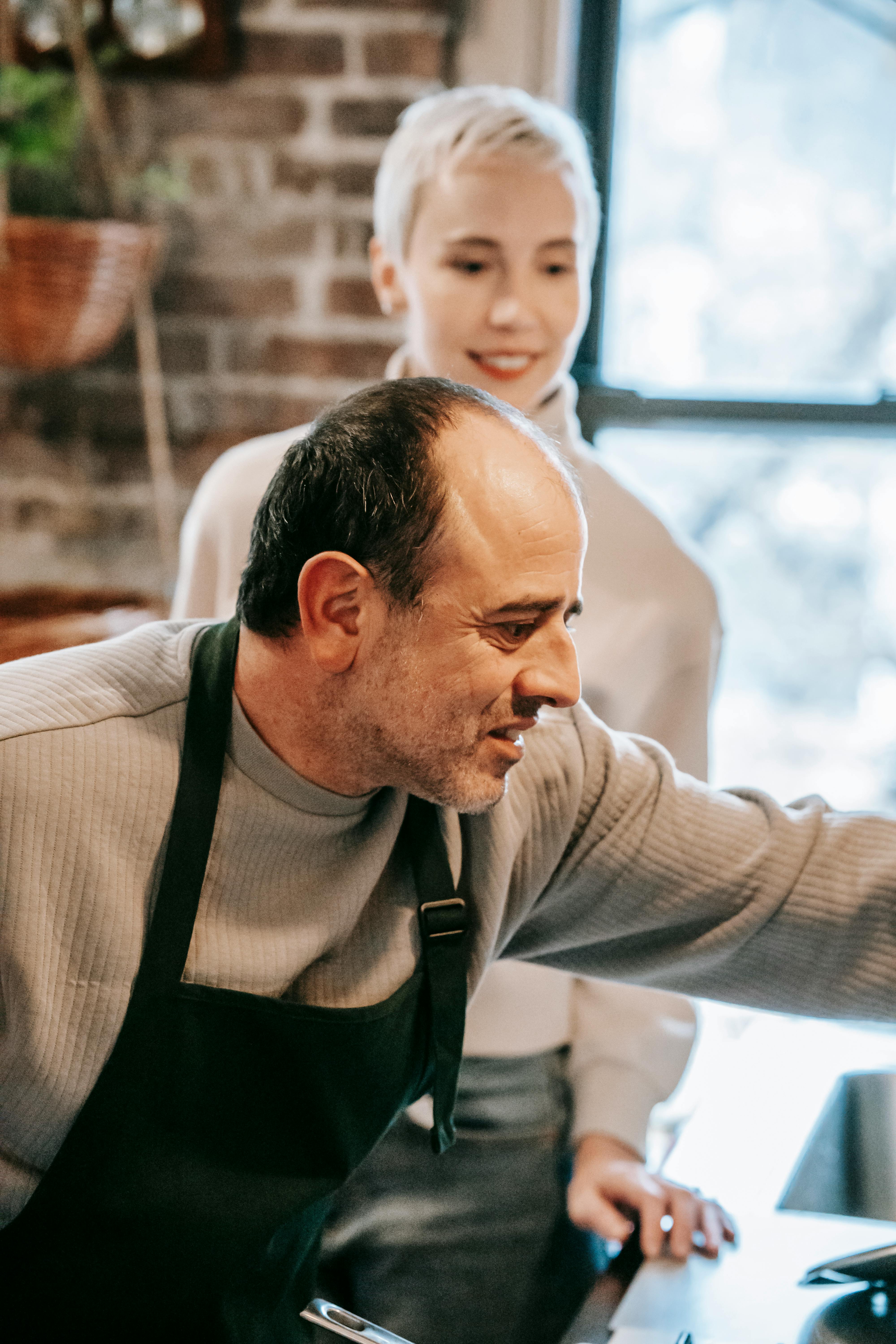 Couple d'âge moyen en train de cuisiner | Source : Pexels