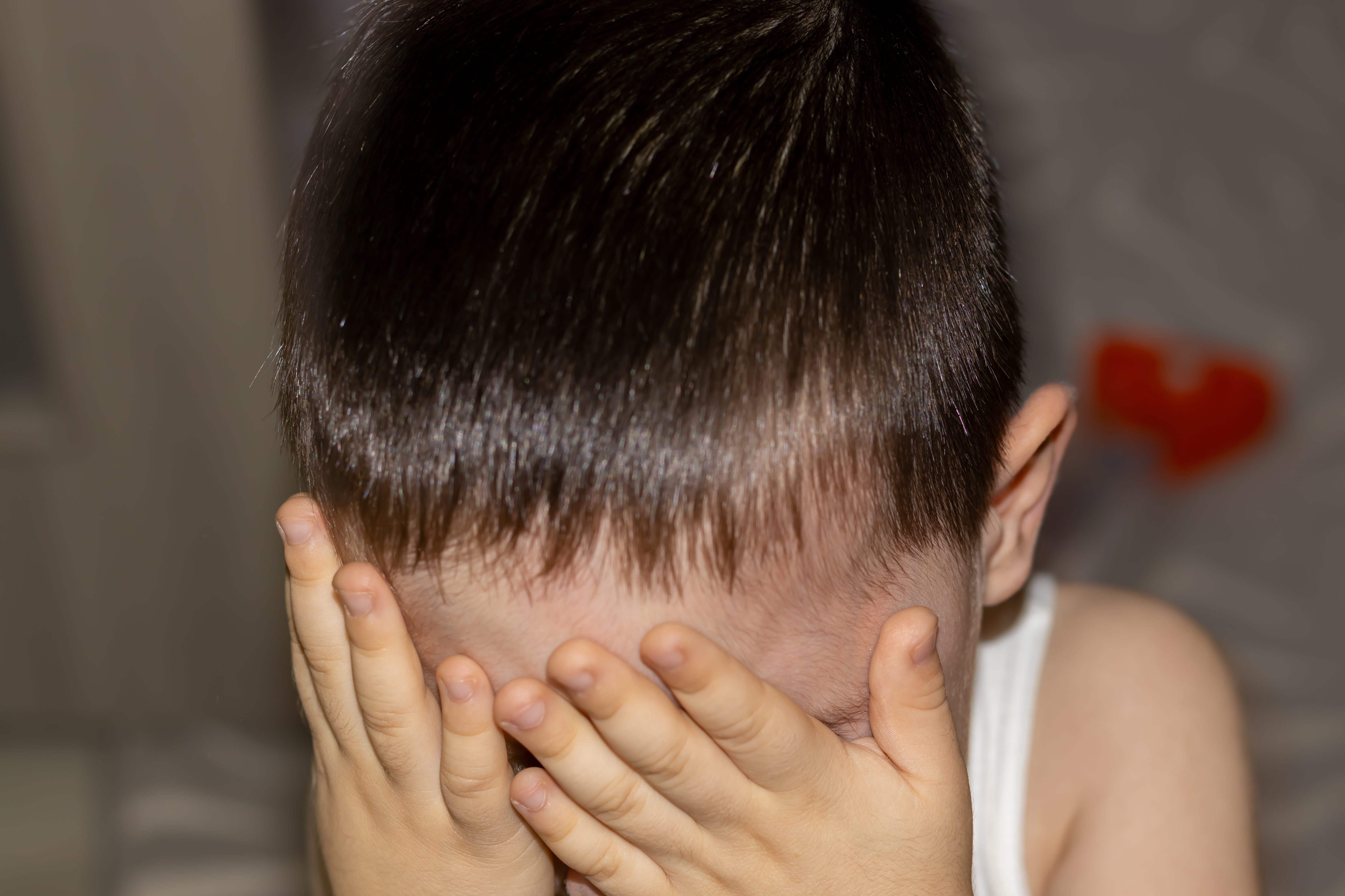 Un enfant qui cache son visage | Source : Shutterstock