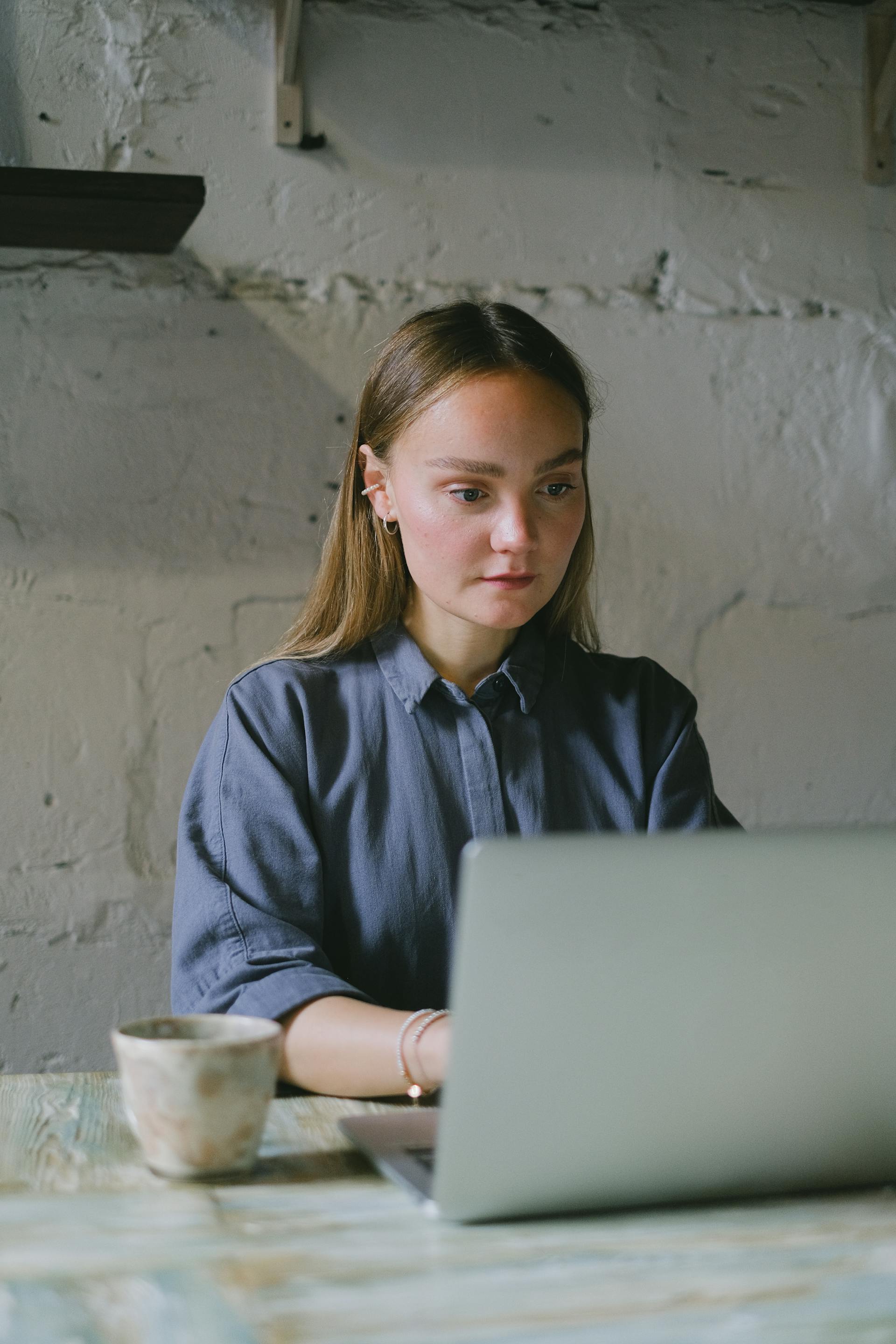 Une femme fixant l'écran d'un ordinateur portable en état de choc | Source : Pexels