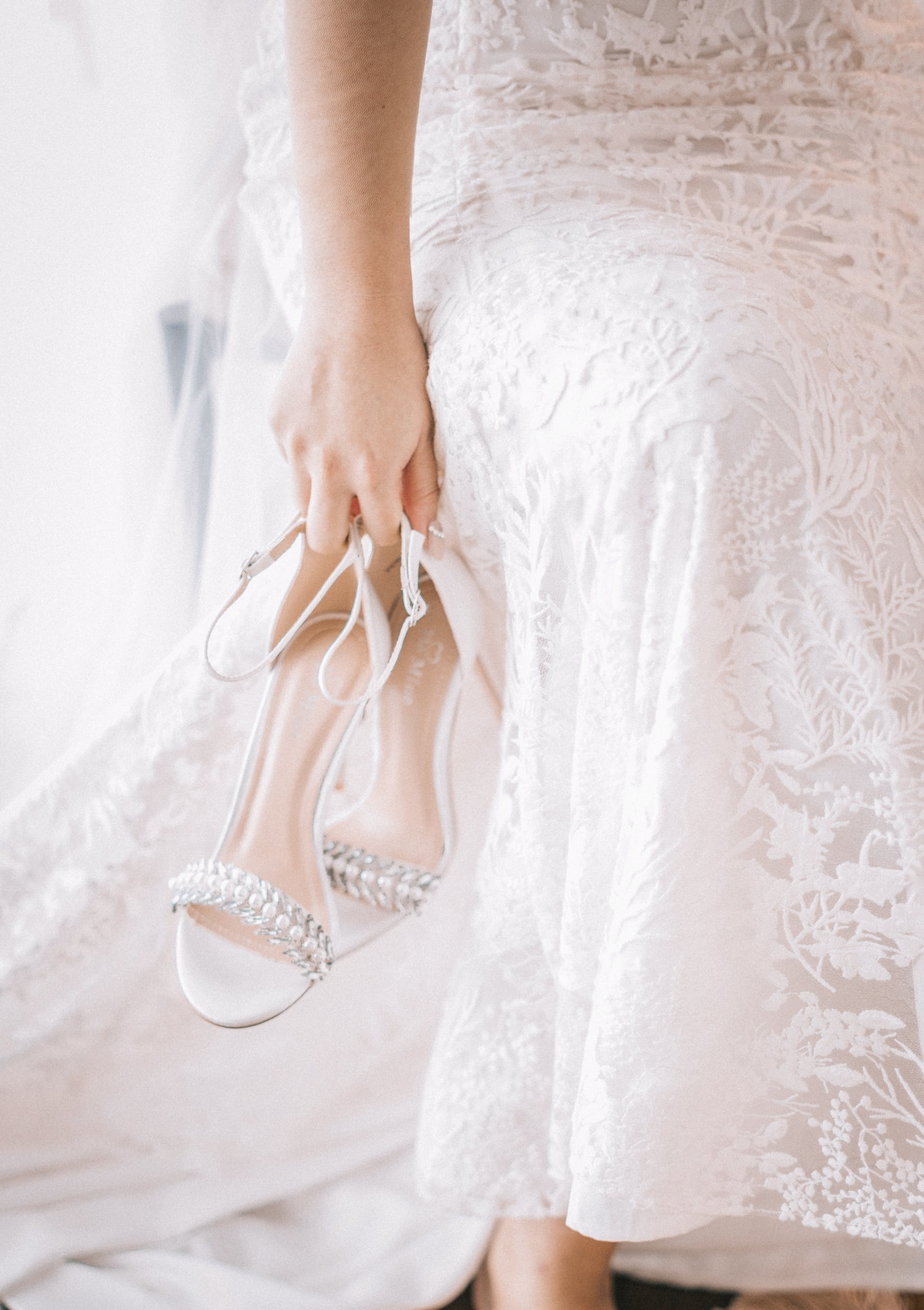 La mariée tient ses chaussures | Source : Pexels