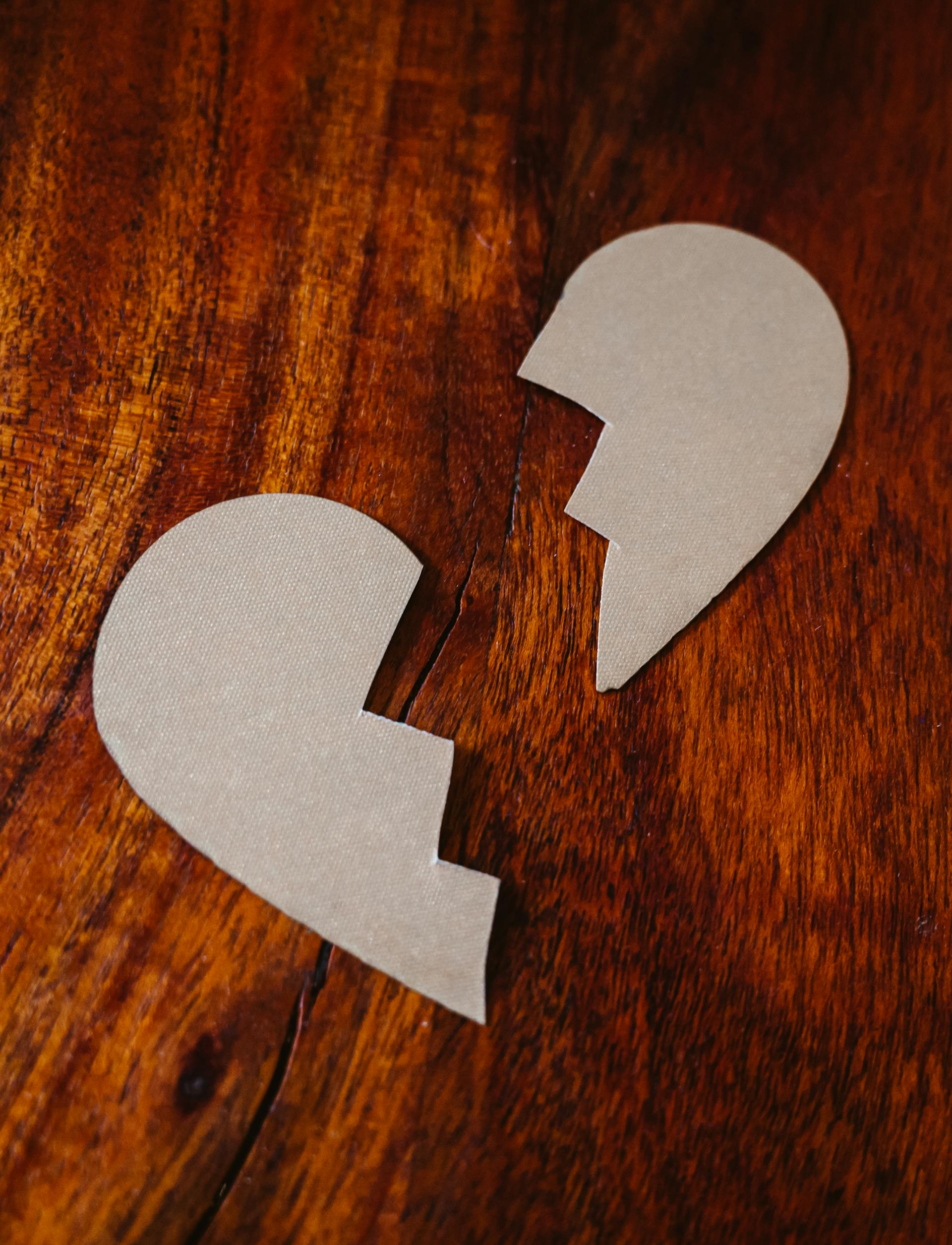 Un carton de cœur brisé posé sur une table en bois | Source : Pexels