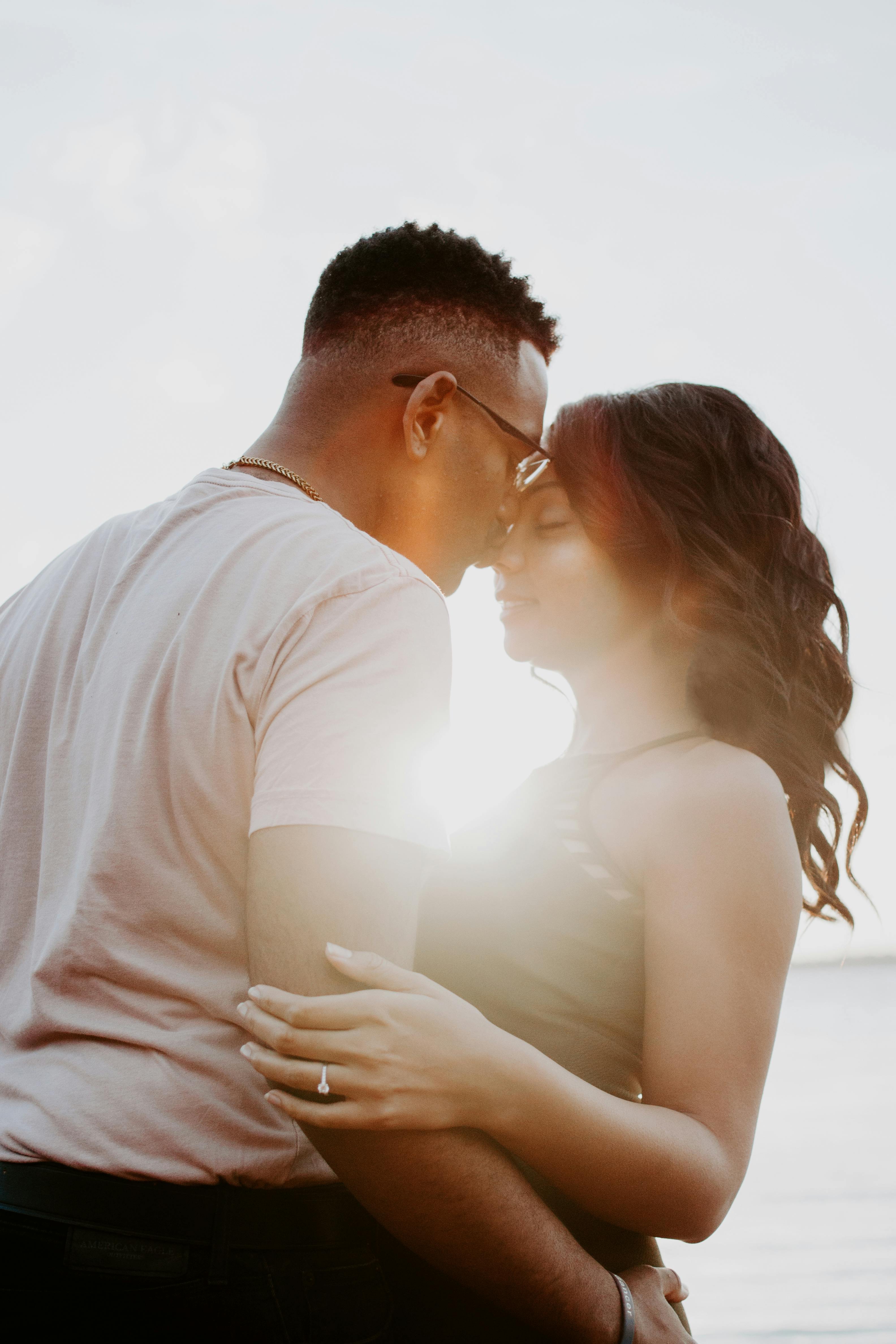Un couple partageant un baiser au milieu d'un coucher de soleil | Source : Pexels