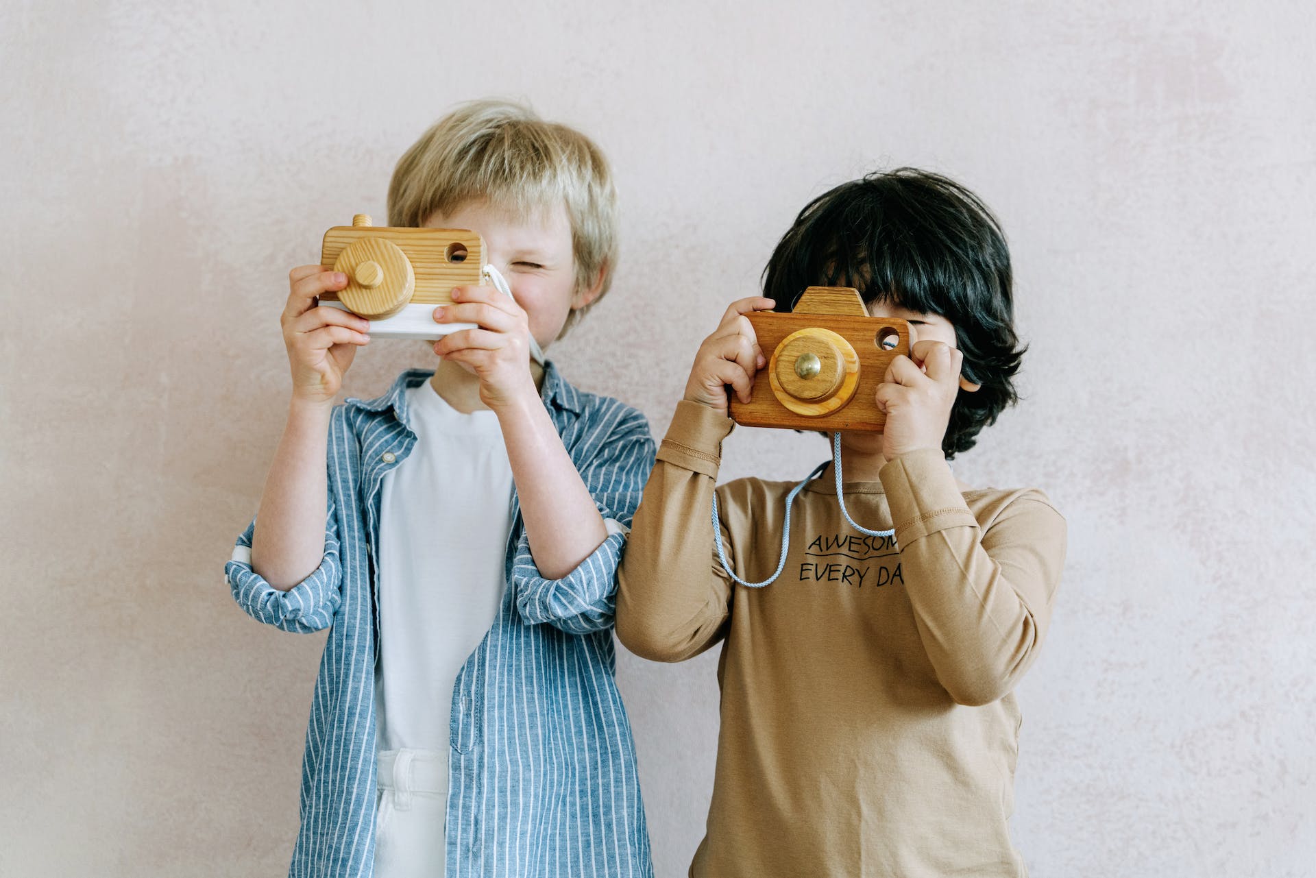 Deux garçons jouant avec un appareil photo jouet | Source : Pexels