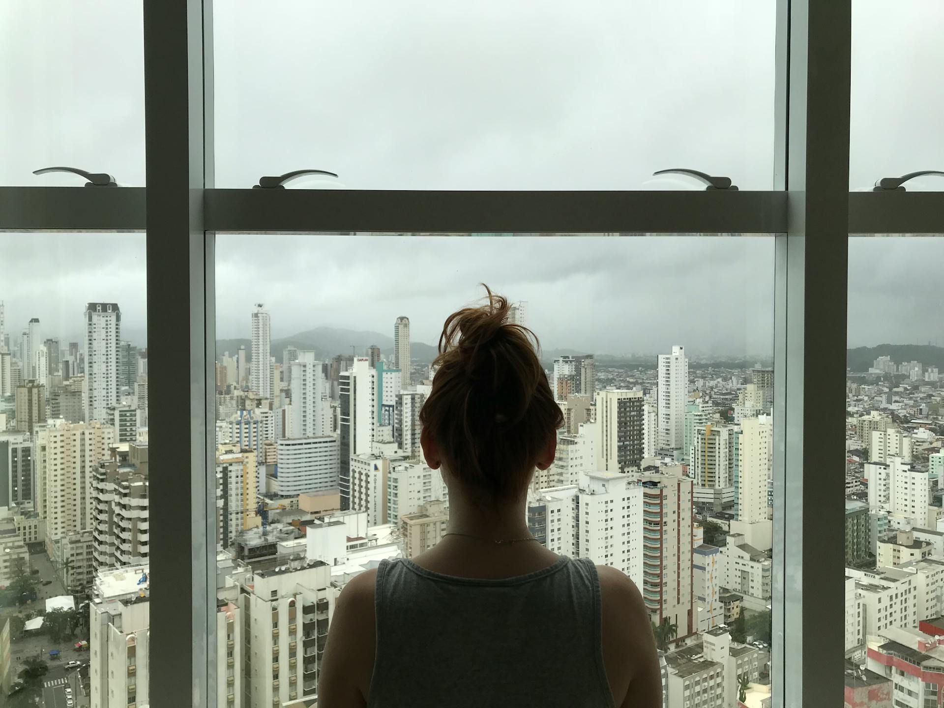 A woman standing in front of a window | Source: Pexels