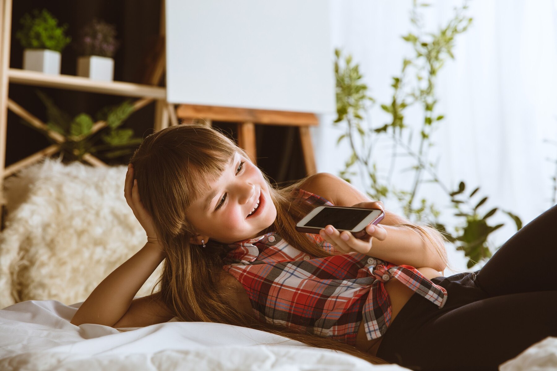 Une jeune fille heureuse avec son téléphone | Source : Freepik