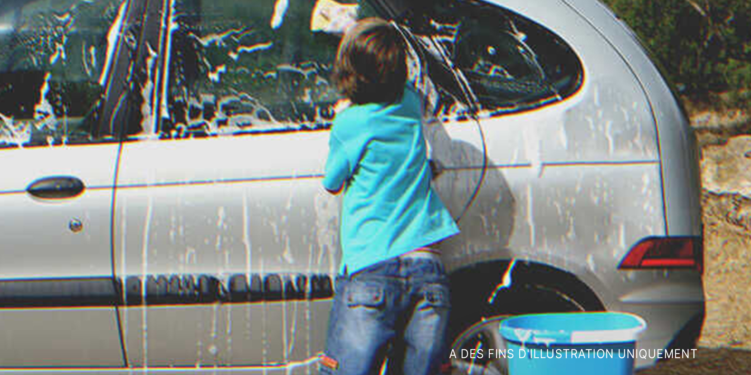 Un garçon en train de nettoyer une voiture | Source : Getty Images