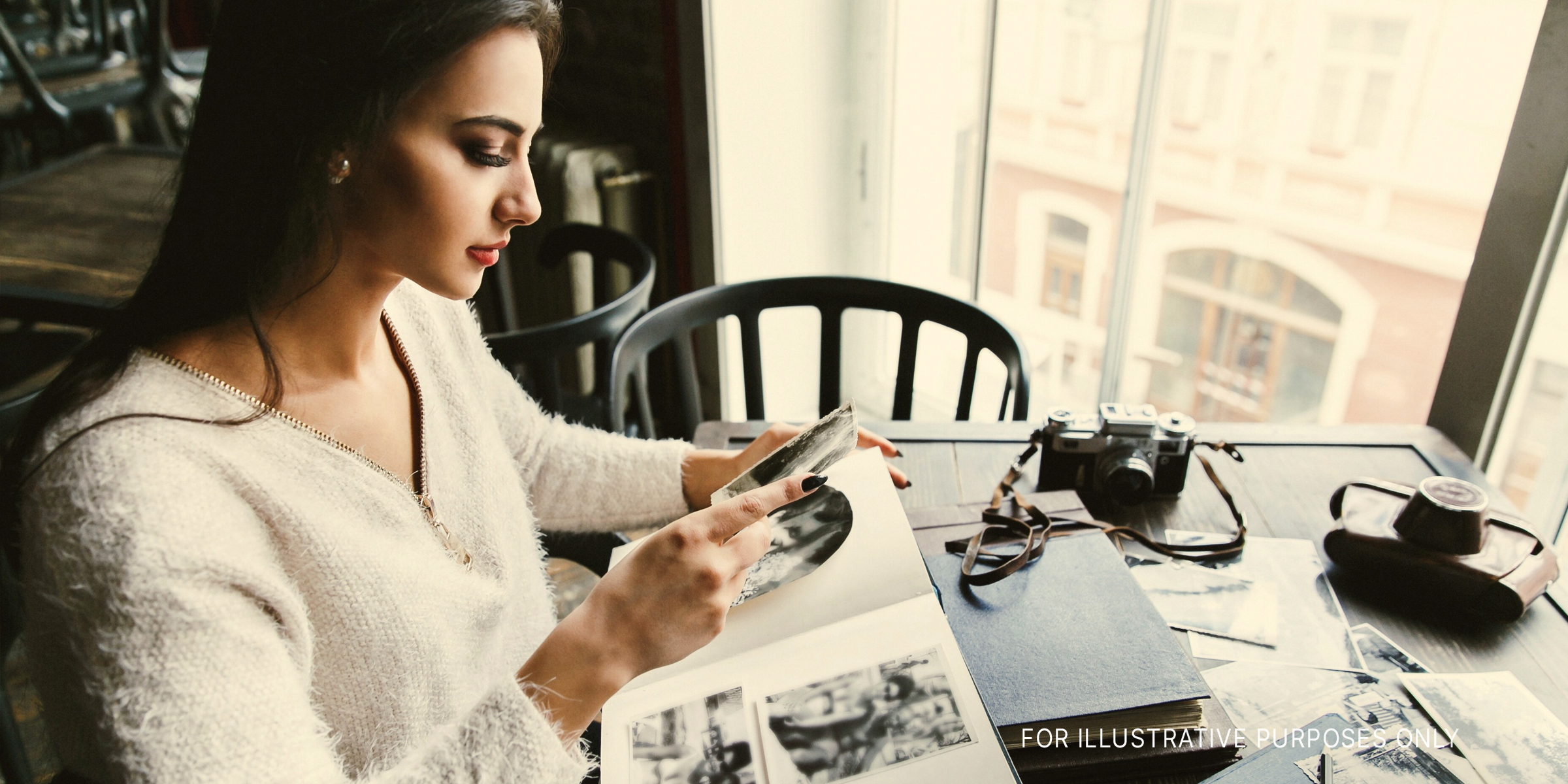 Une femme regardant un album photos | Source : Shutterstock