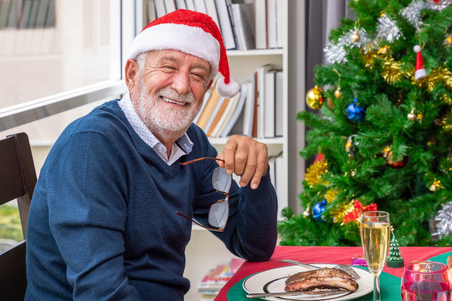 Homme d'âge moyen discutant pendant un repas de Noël | Source : Freepik