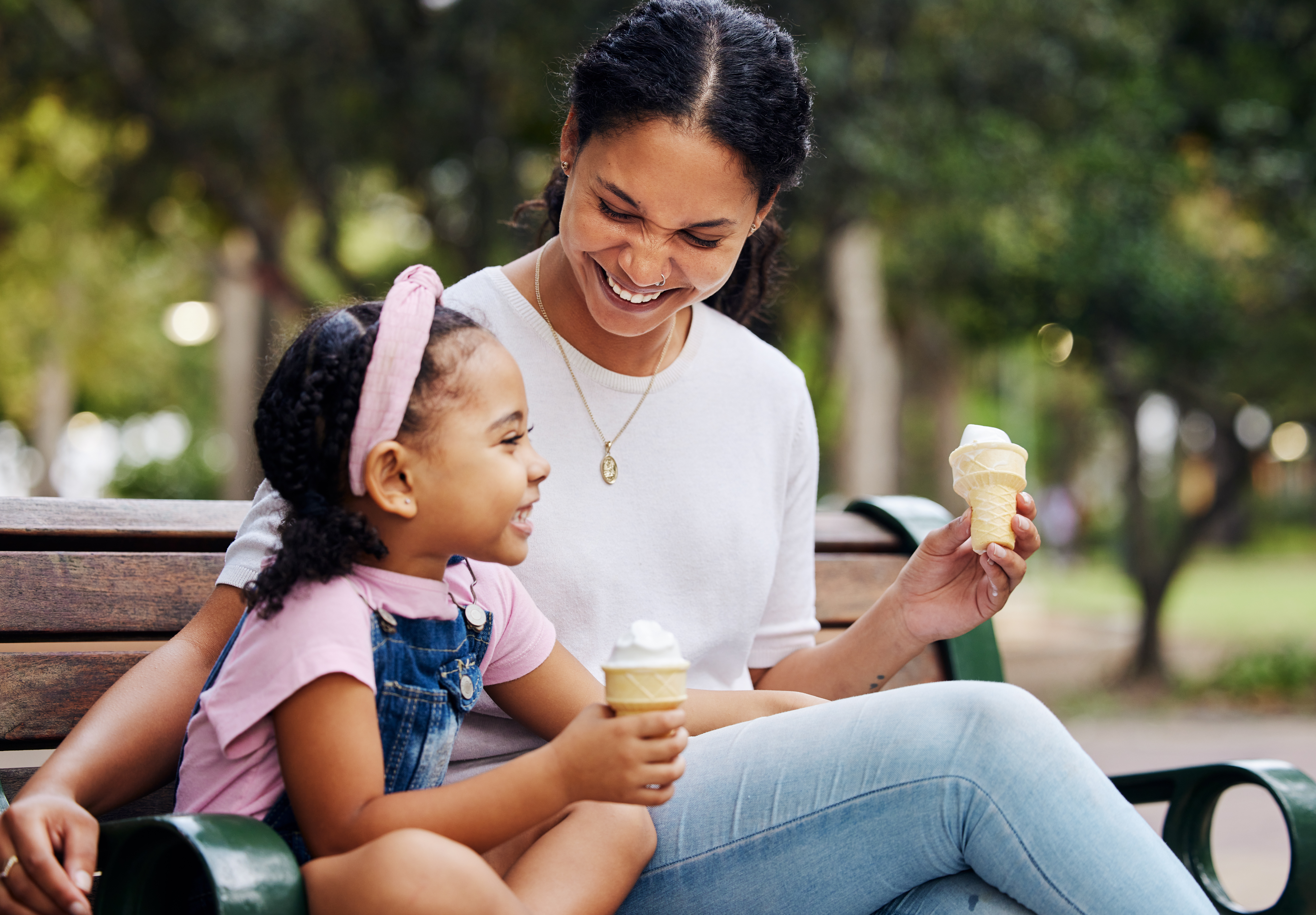 Une mère et sa fille dégustant une glace sur un banc public | Source : Getty Images