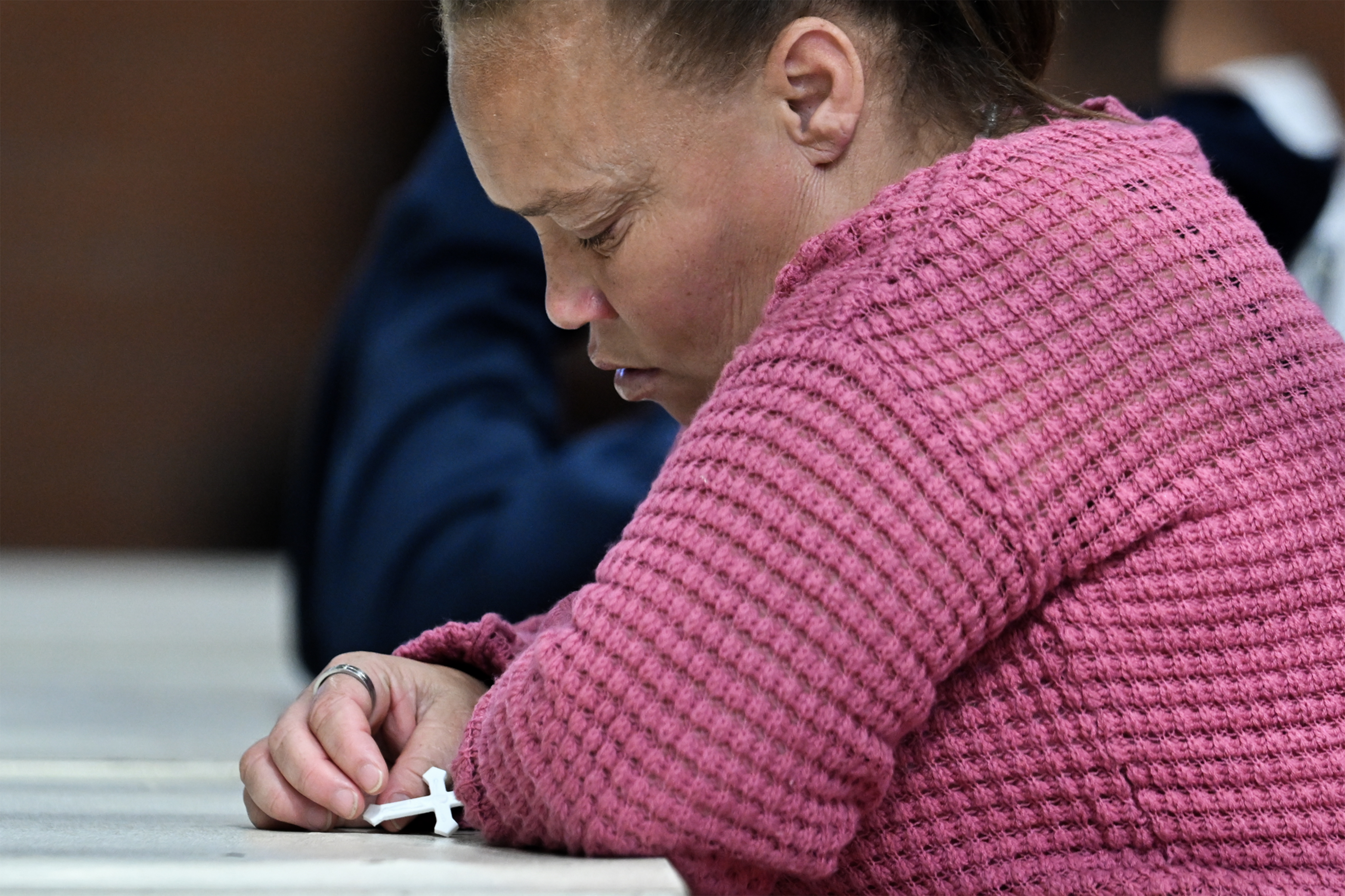 Racquel Smith est vue tenant une croix lors du procès dans l'affaire de la disparition de Joshlin Smith au jour 7 au centre polyvalent de White City, le 11 mars 2025, à Saldanha Bay, en Afrique du Sud | Source : Getty Images