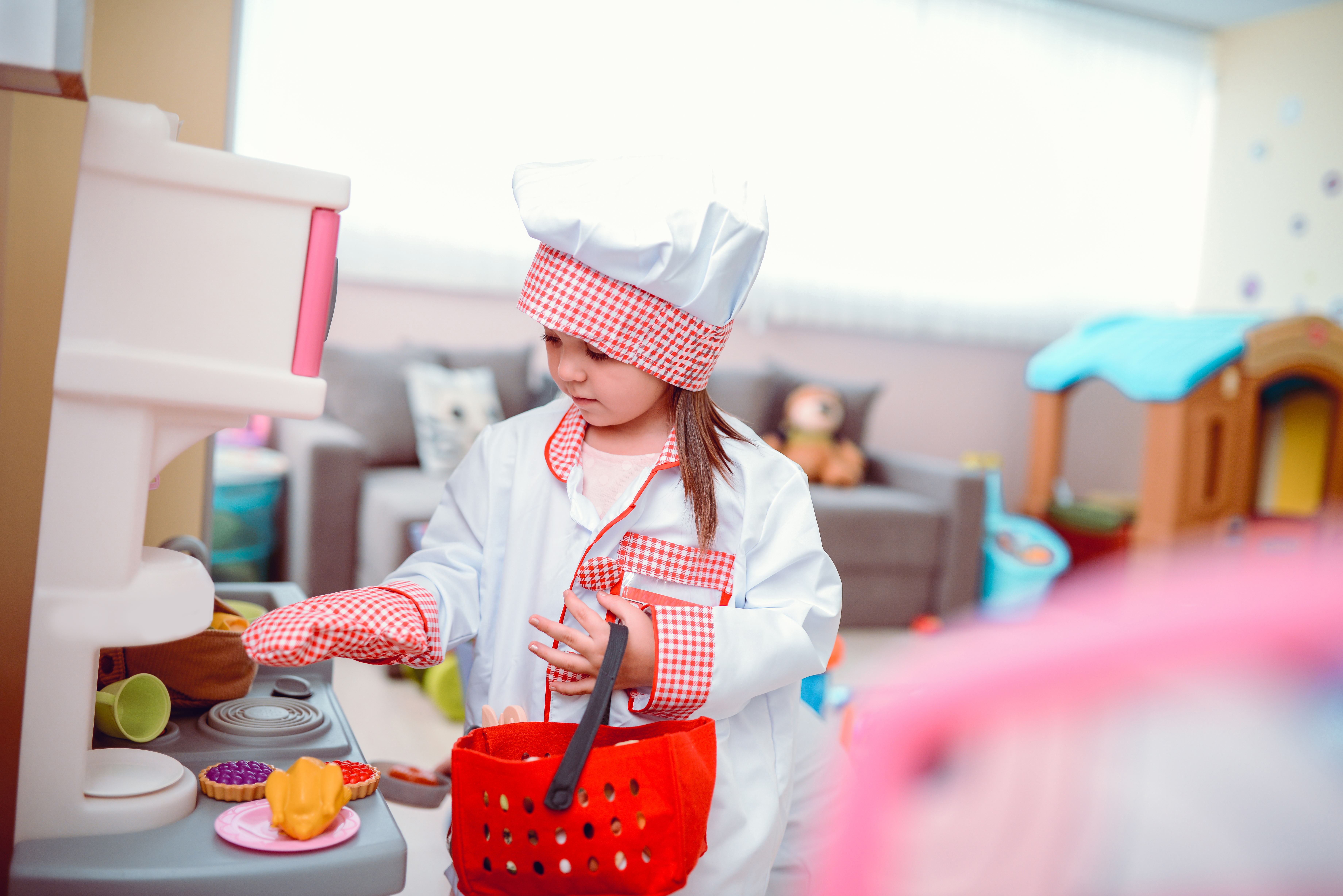 Une petite fille joue au chef cuisinier dans une classe d'école maternelle | Source : Getty Images