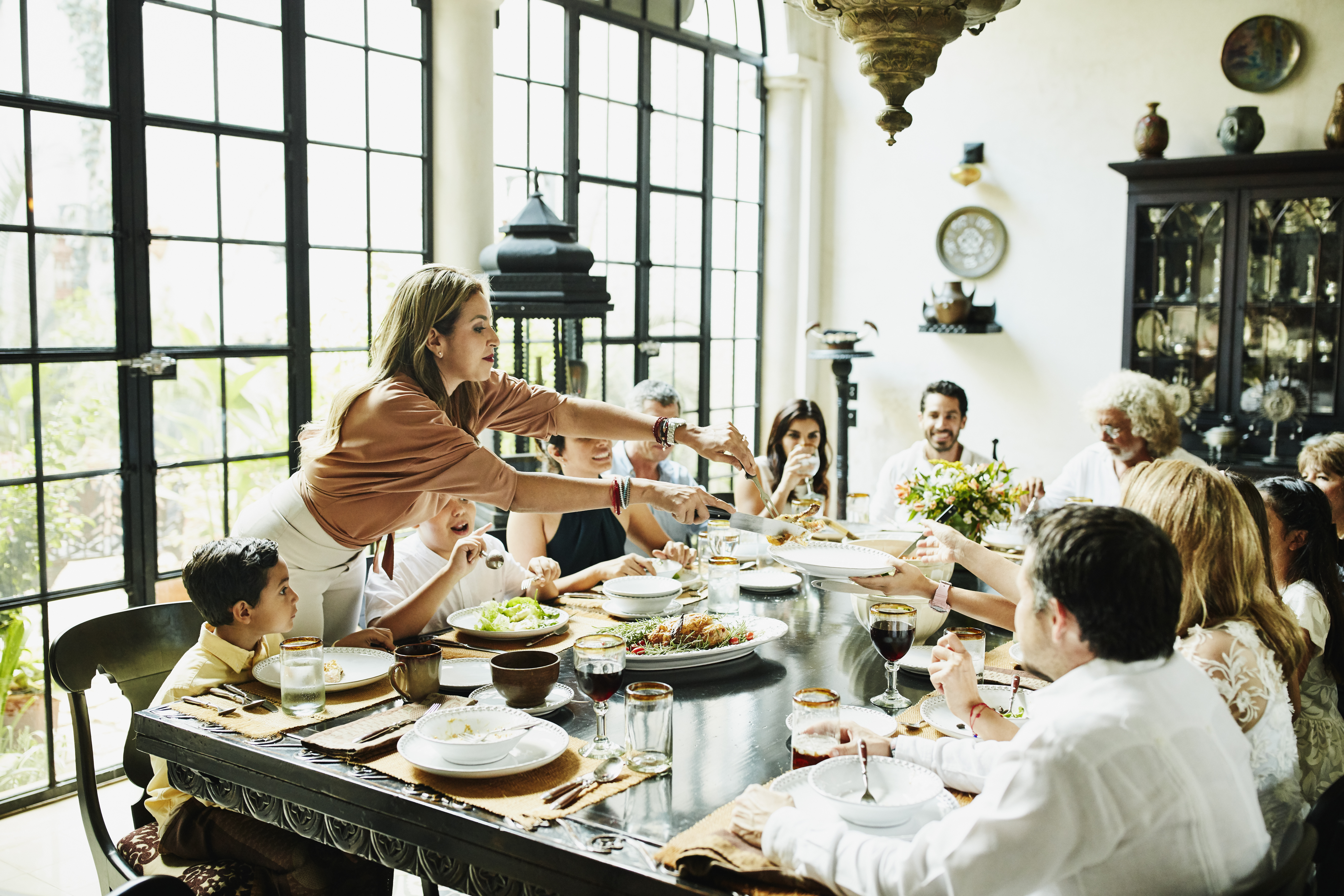 Une famille réunie autour d'une table lors d’un dîner | Source : Getty Images