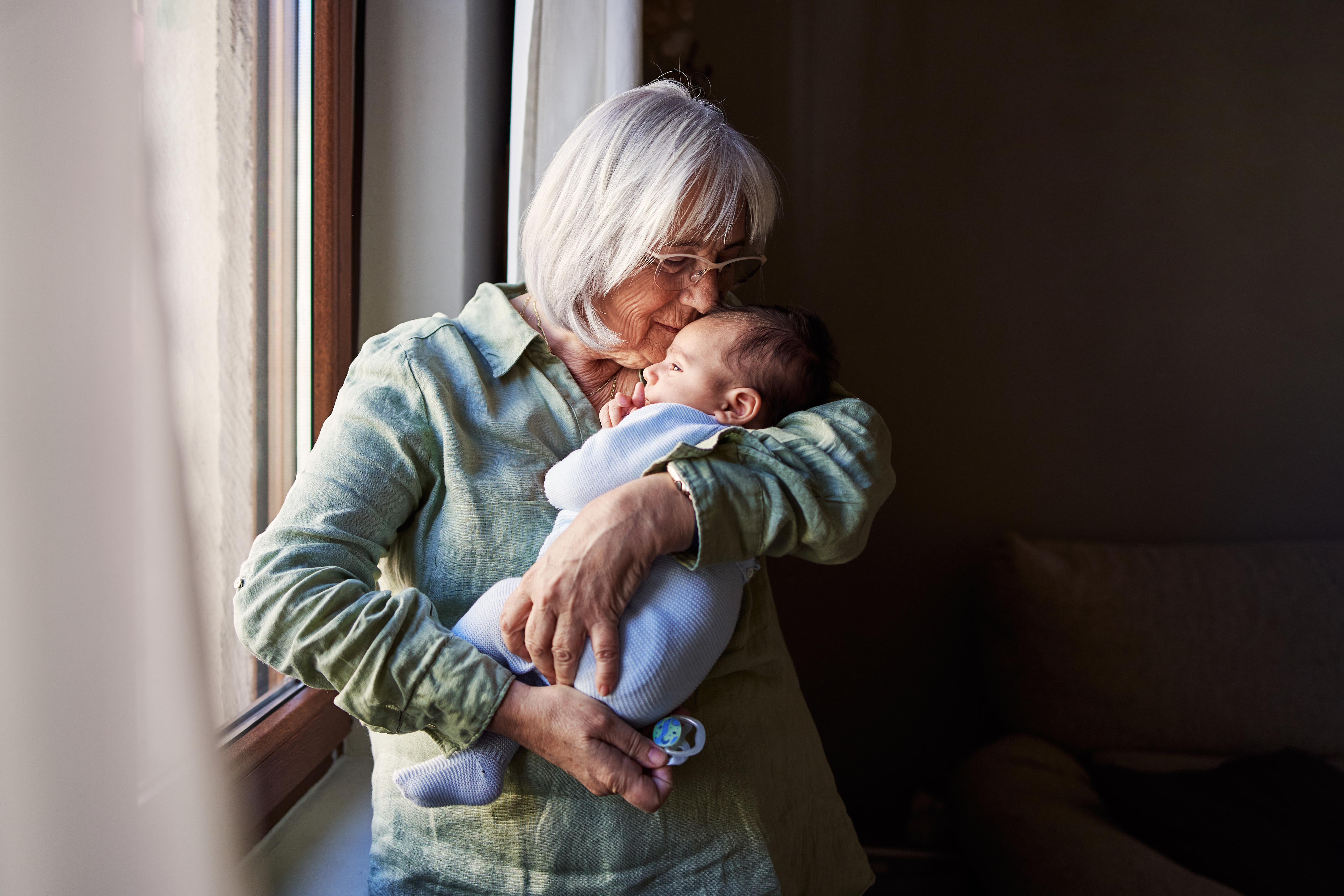 An elderly woman caring for a baby | Source: Getty Images