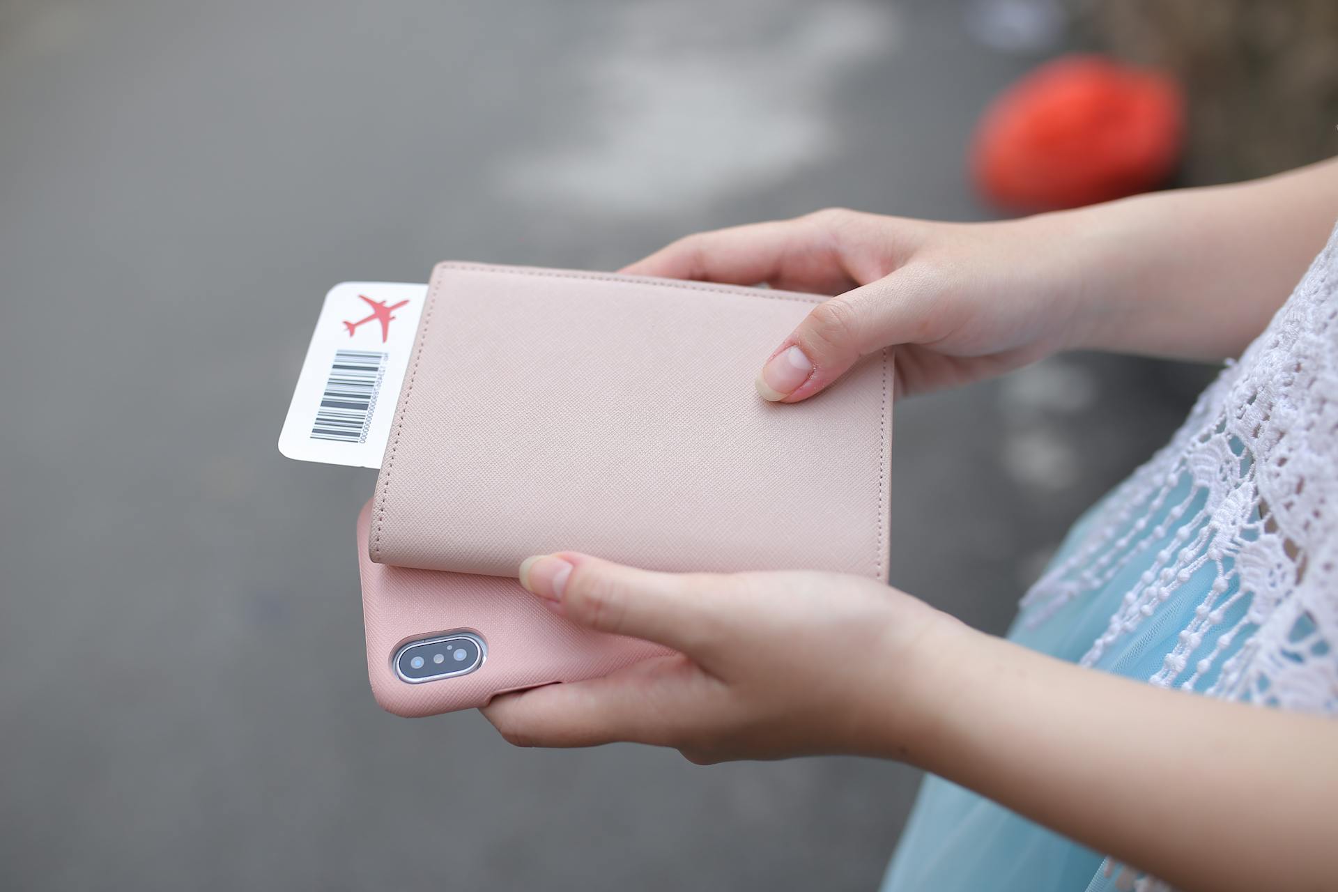 Une femme tenant un ticket et un téléphone | Source : Pexels