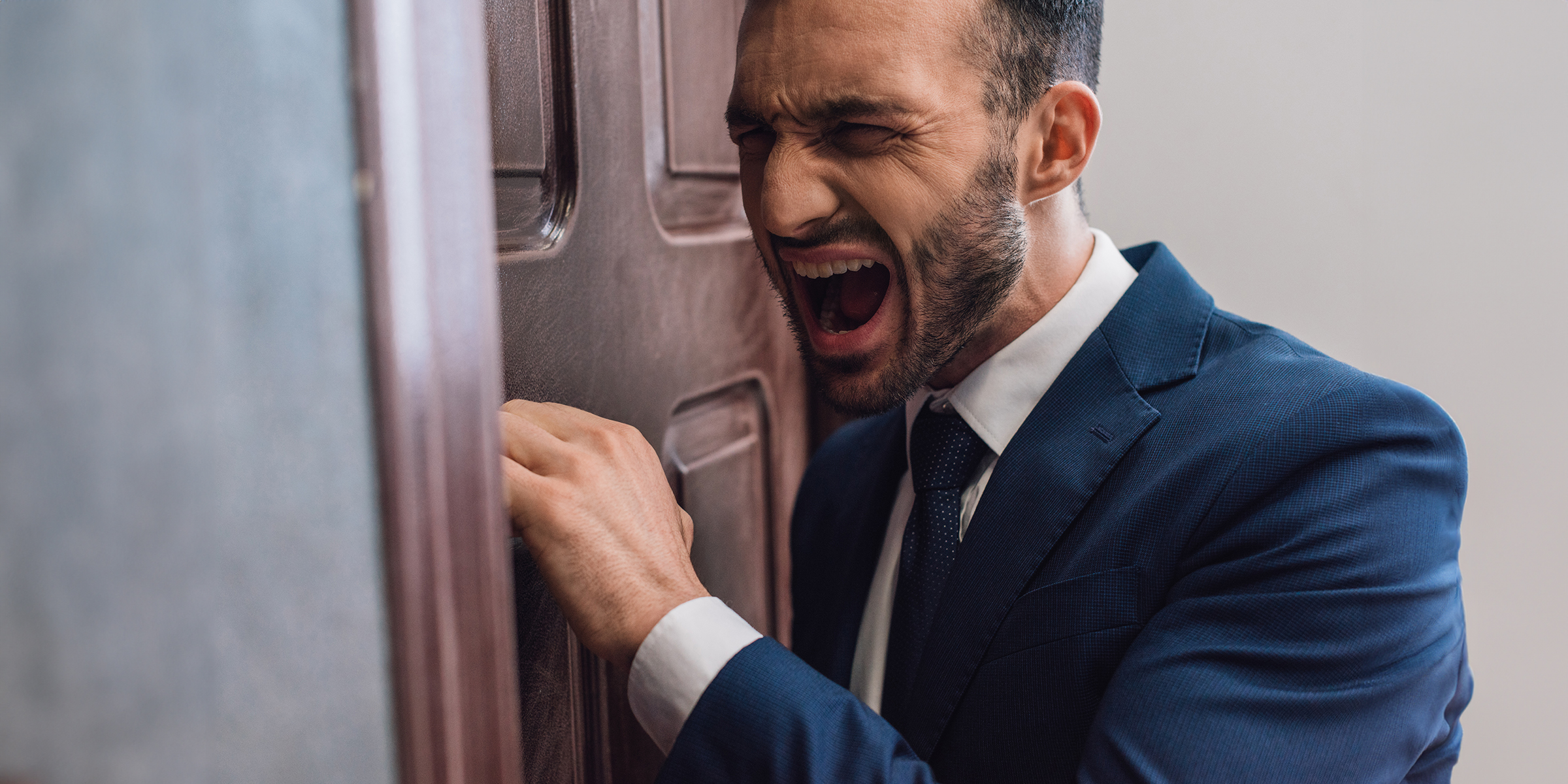 Un homme en colère qui frappe à une porte | Source : Shutterstock