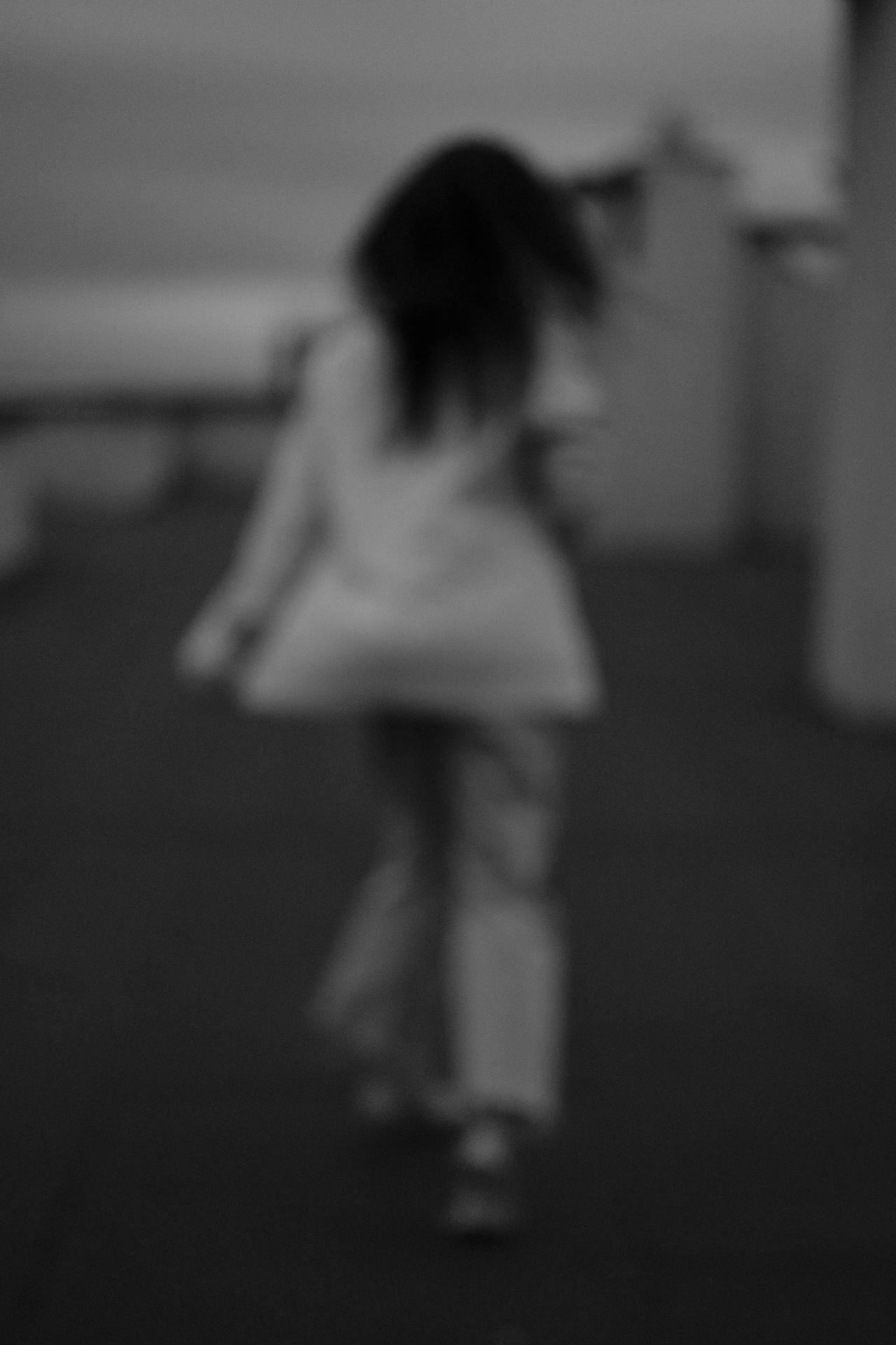 Grayscale photo of a woman walking away | Source: Pexels