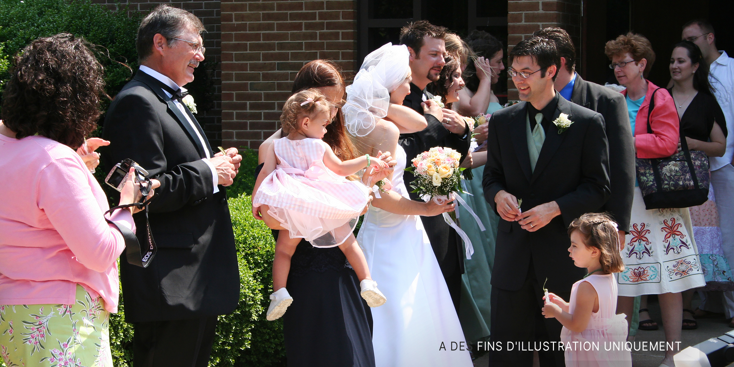 Un groupe de gens se tenant à l'extérieur lors d'un mariage | Source : Flickr / Gavin St. Ours (CC BY 2.0)