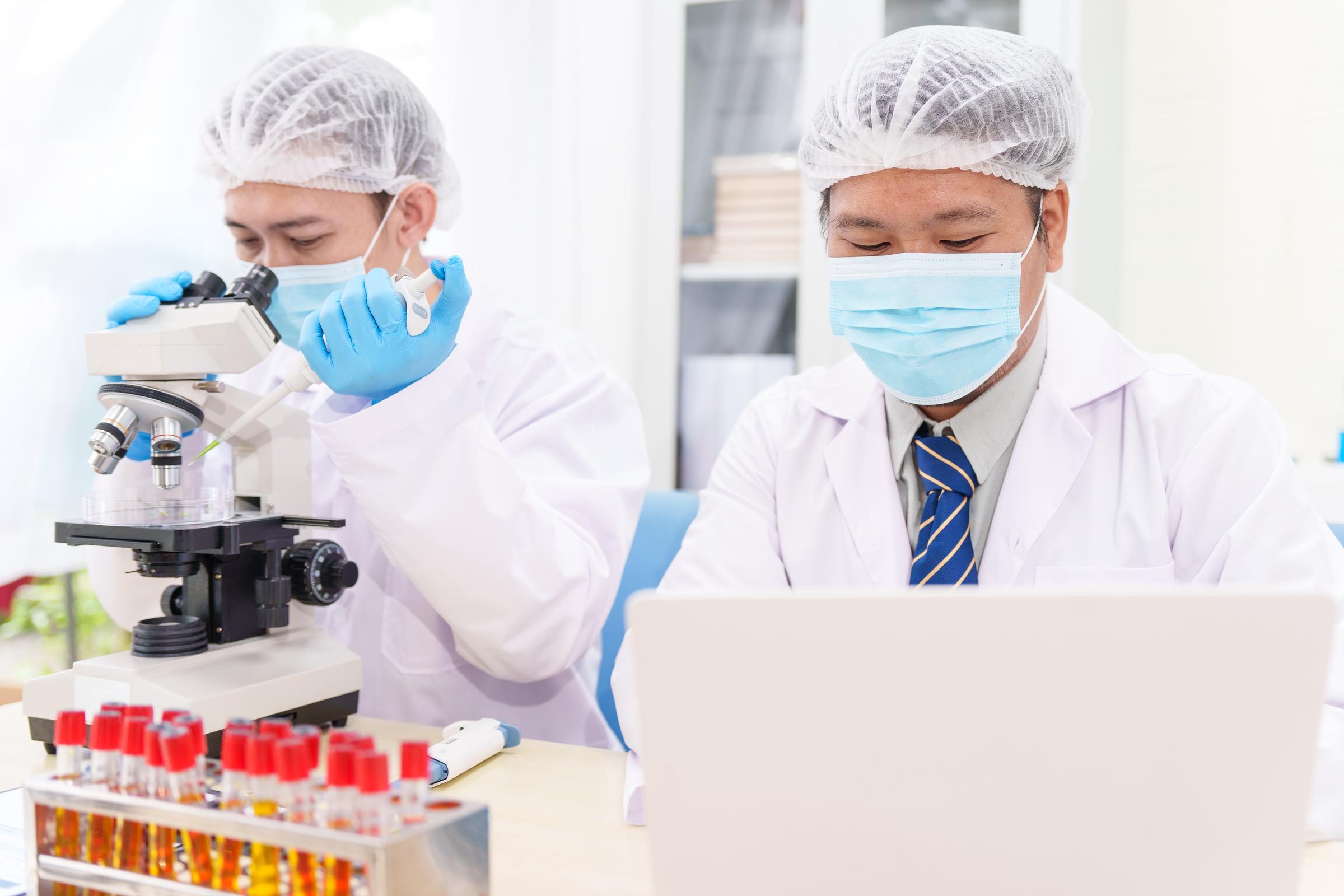 Des scientifiques en blouse de laboratoire, réalisant une étude | Source : Getty Images