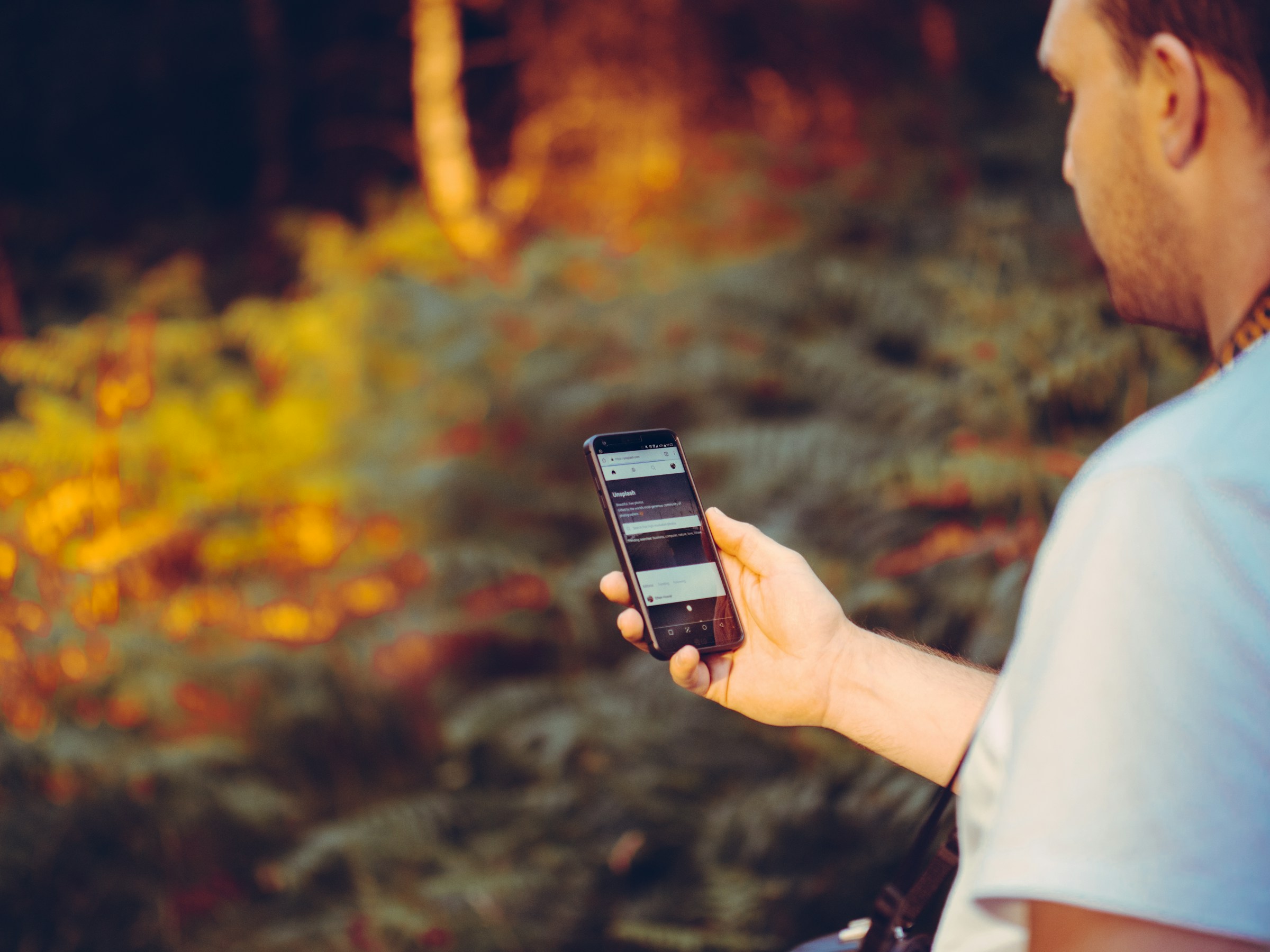 Un homme tenant un téléphone | Source : Unsplash