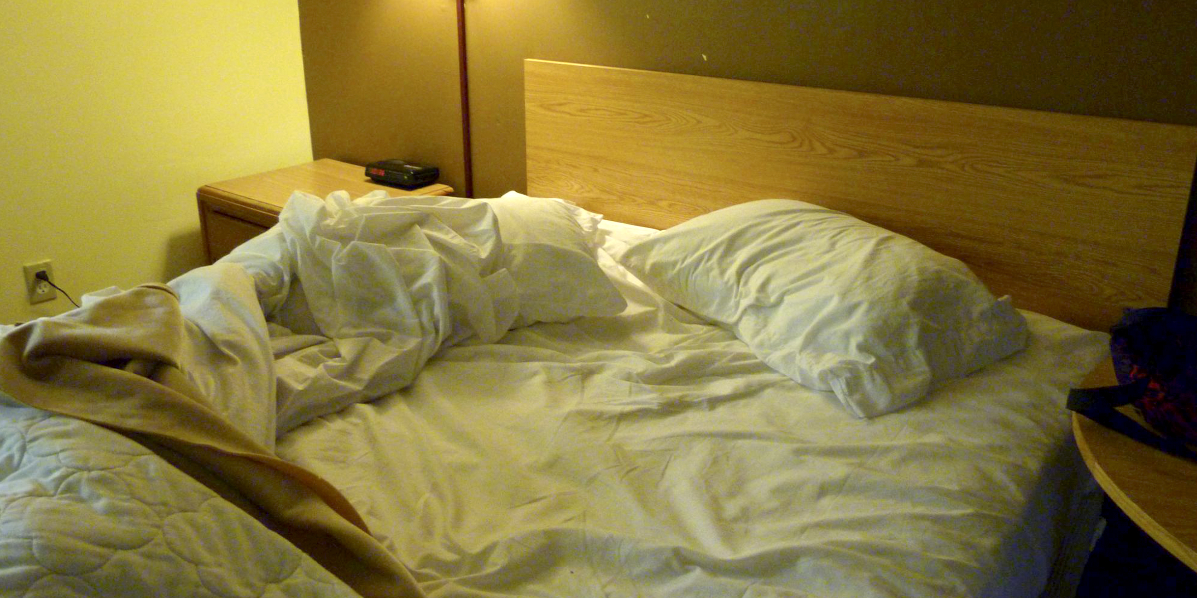 Un lit en désordre avec des draps et des oreillers blancs | Source : flickr.com/CC BY 2.0/Rusty Clark ~ 100K Photos