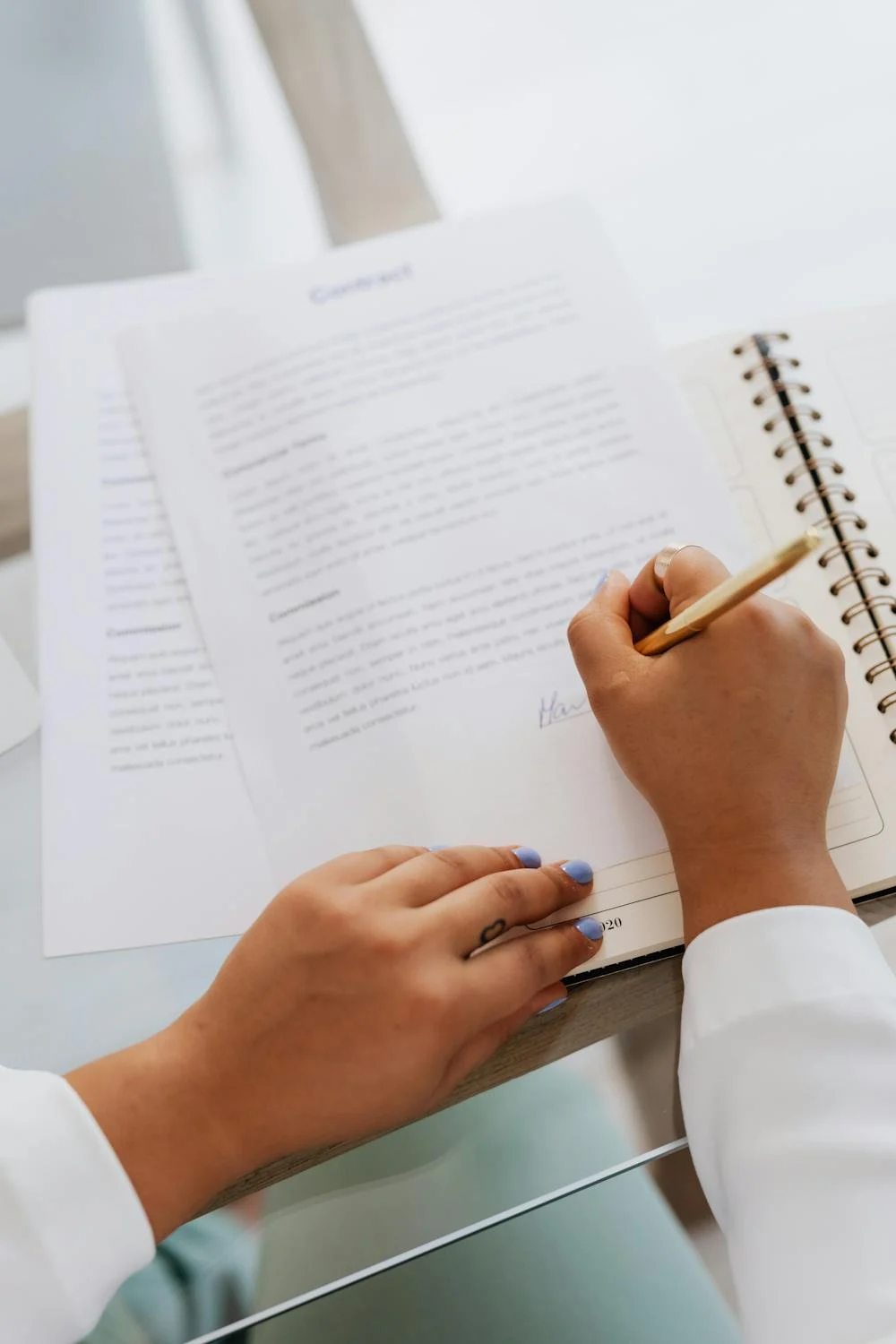 Une femme qui signe des papiers | Source : Pexels