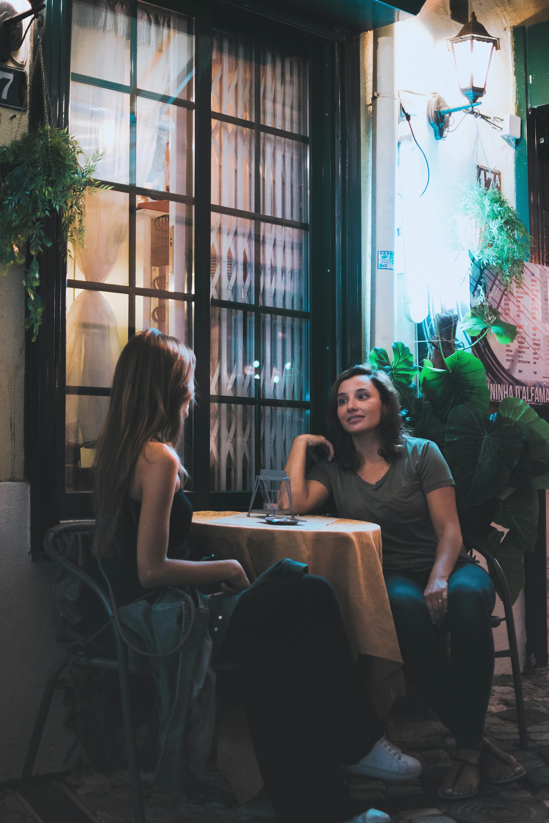 Deux femmes discutent dans un café en plein air | Source : Pexels