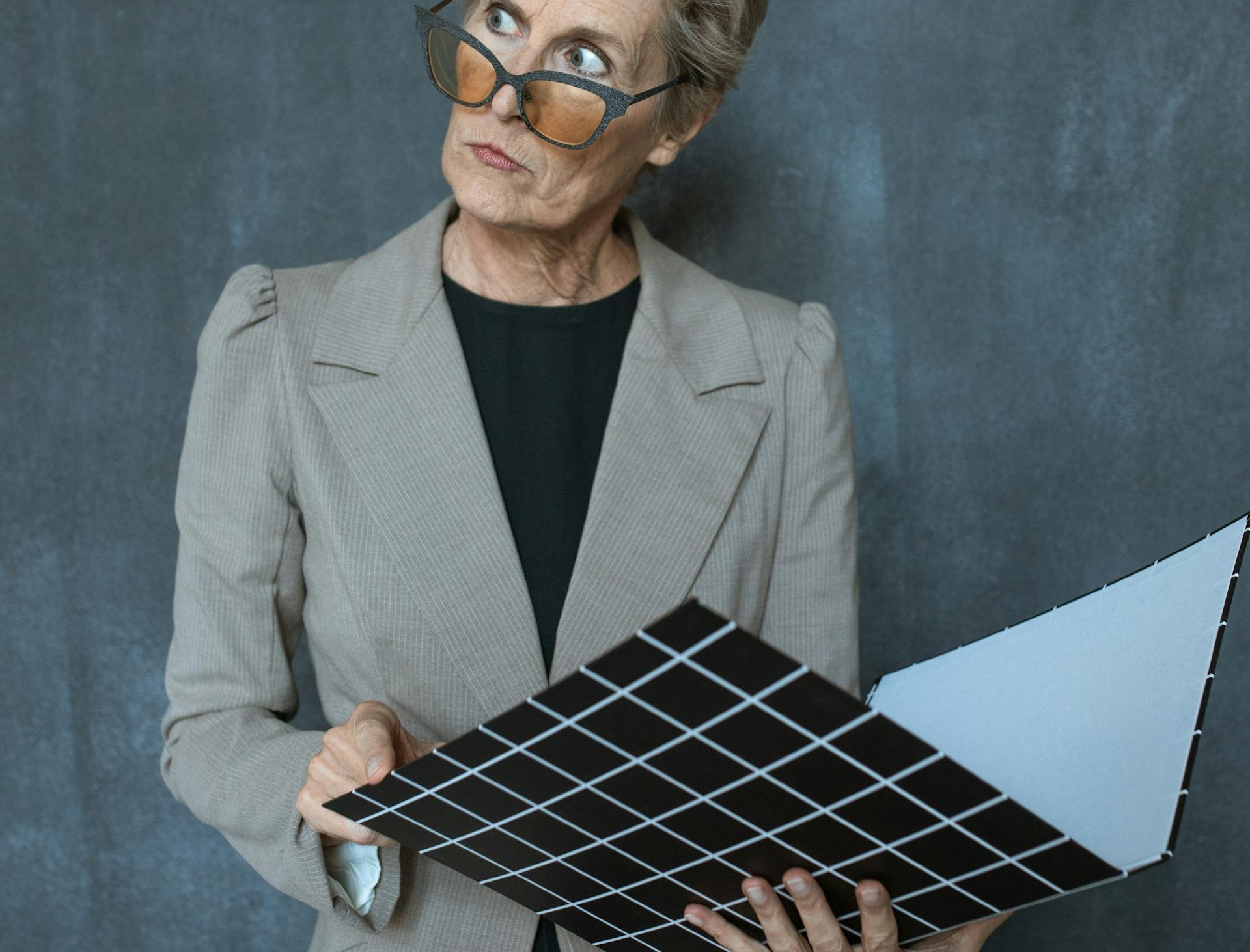 An elderly lady holding a file | Source: Pexels