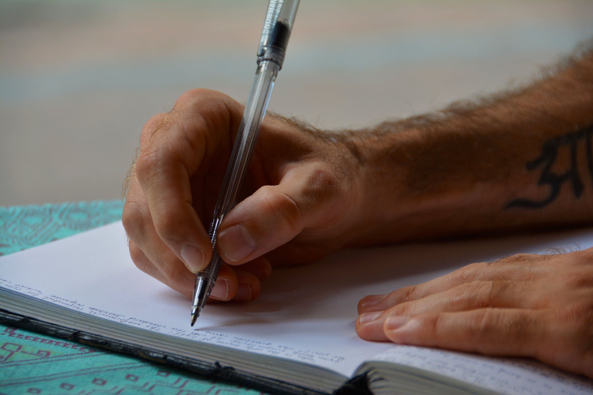 Homme écrivant dans un carnet | Source : Pexels